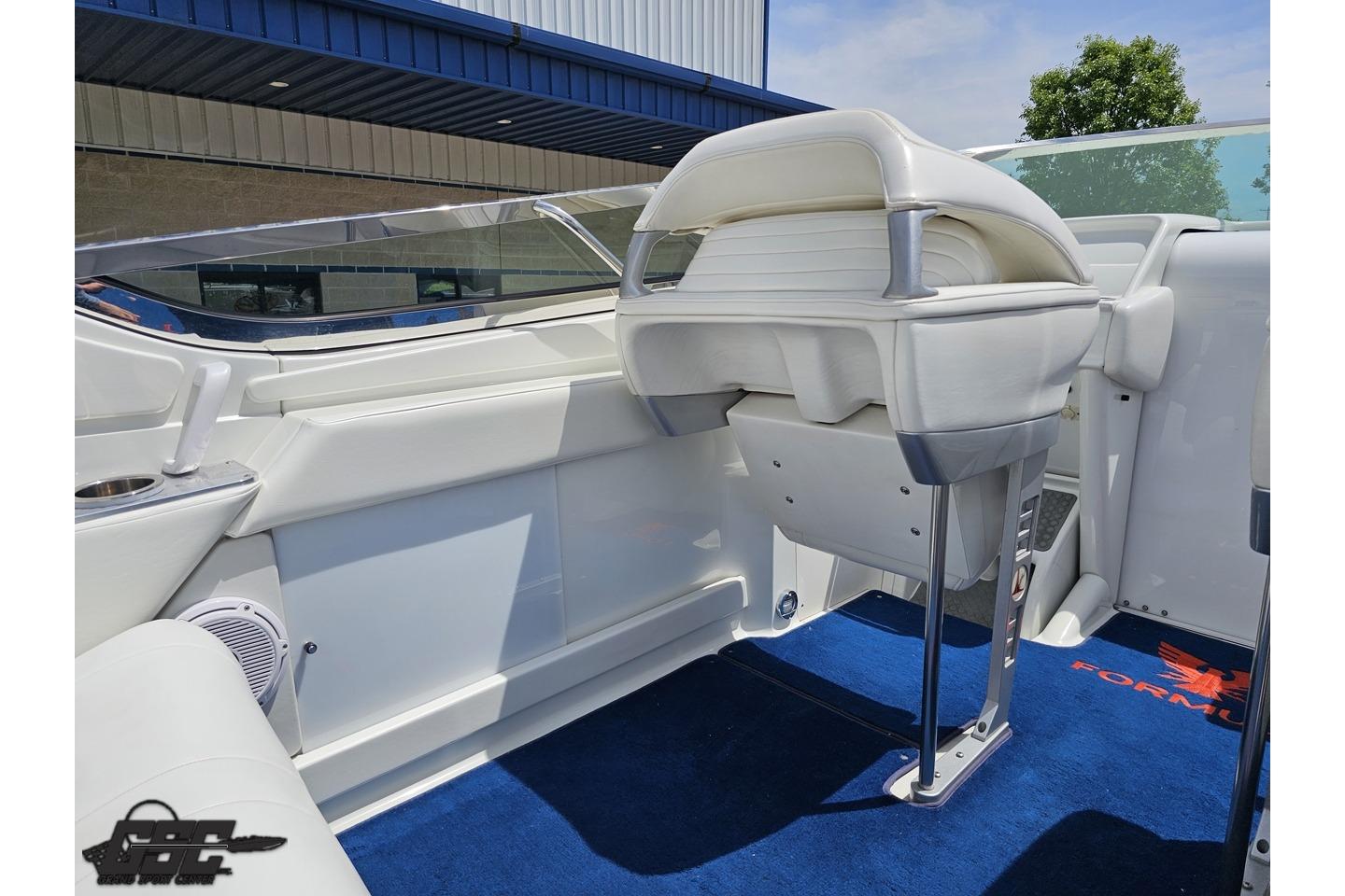 2002 Formula 382 FASTech boat interior with white seating and blue carpet.