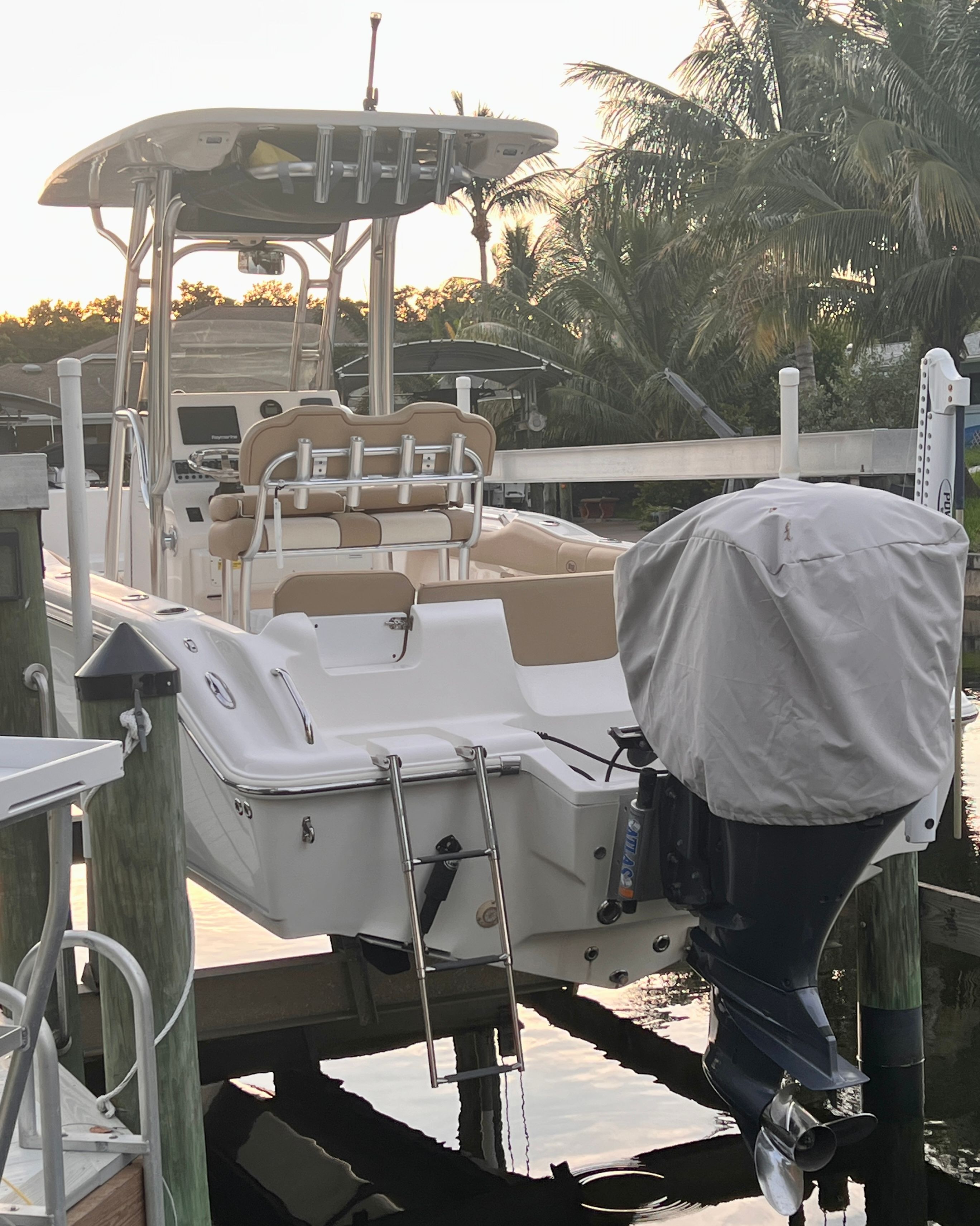 A 2018 Key West 239 FS boat is docked. It features a covered outboard motor.