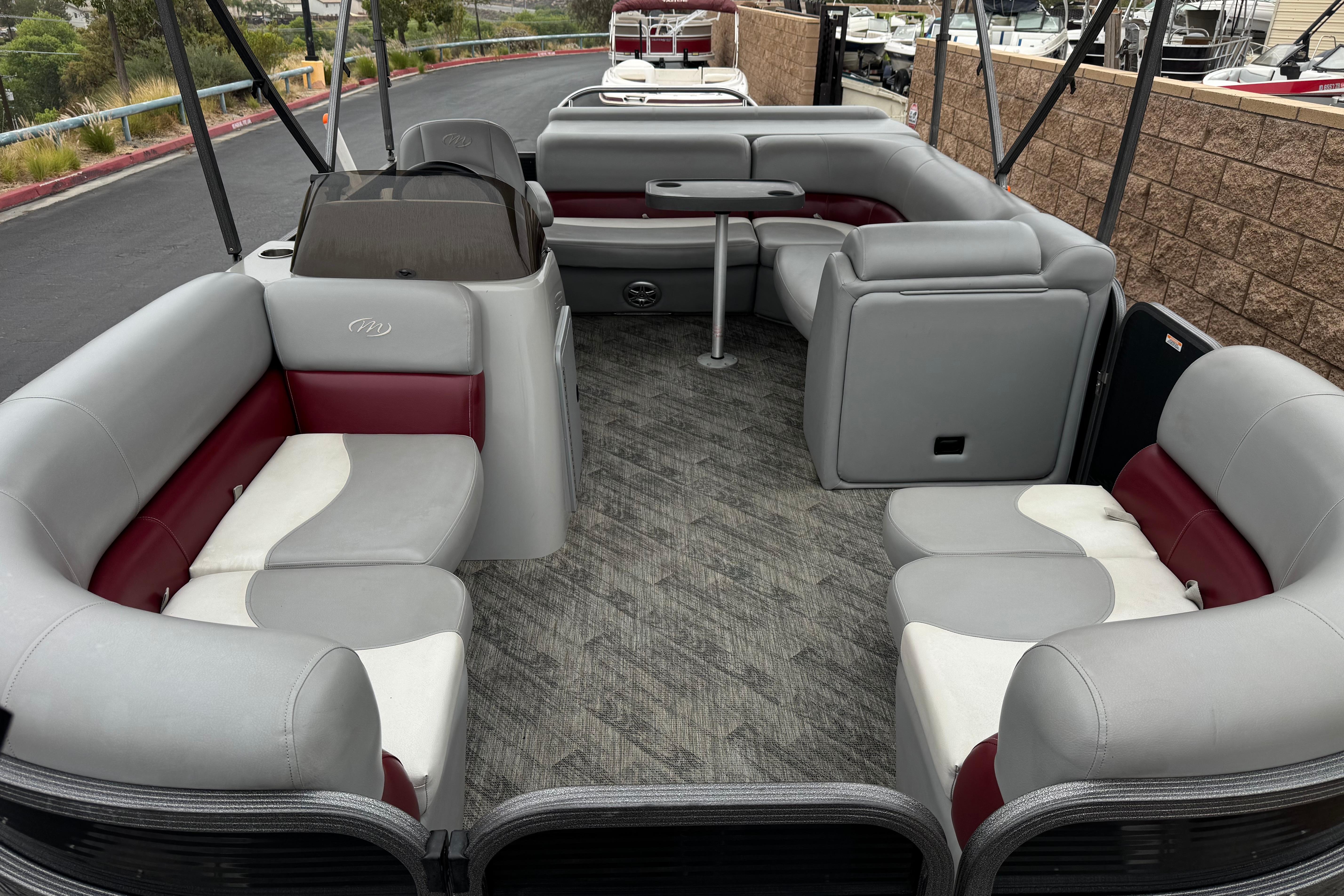 2020 Manitou 18 Aurora LE pontoon boat interior with gray and red seating.