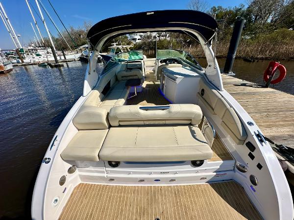 The image shows a 2018 Regal 3300 boat with beige upholstery and an open deck.