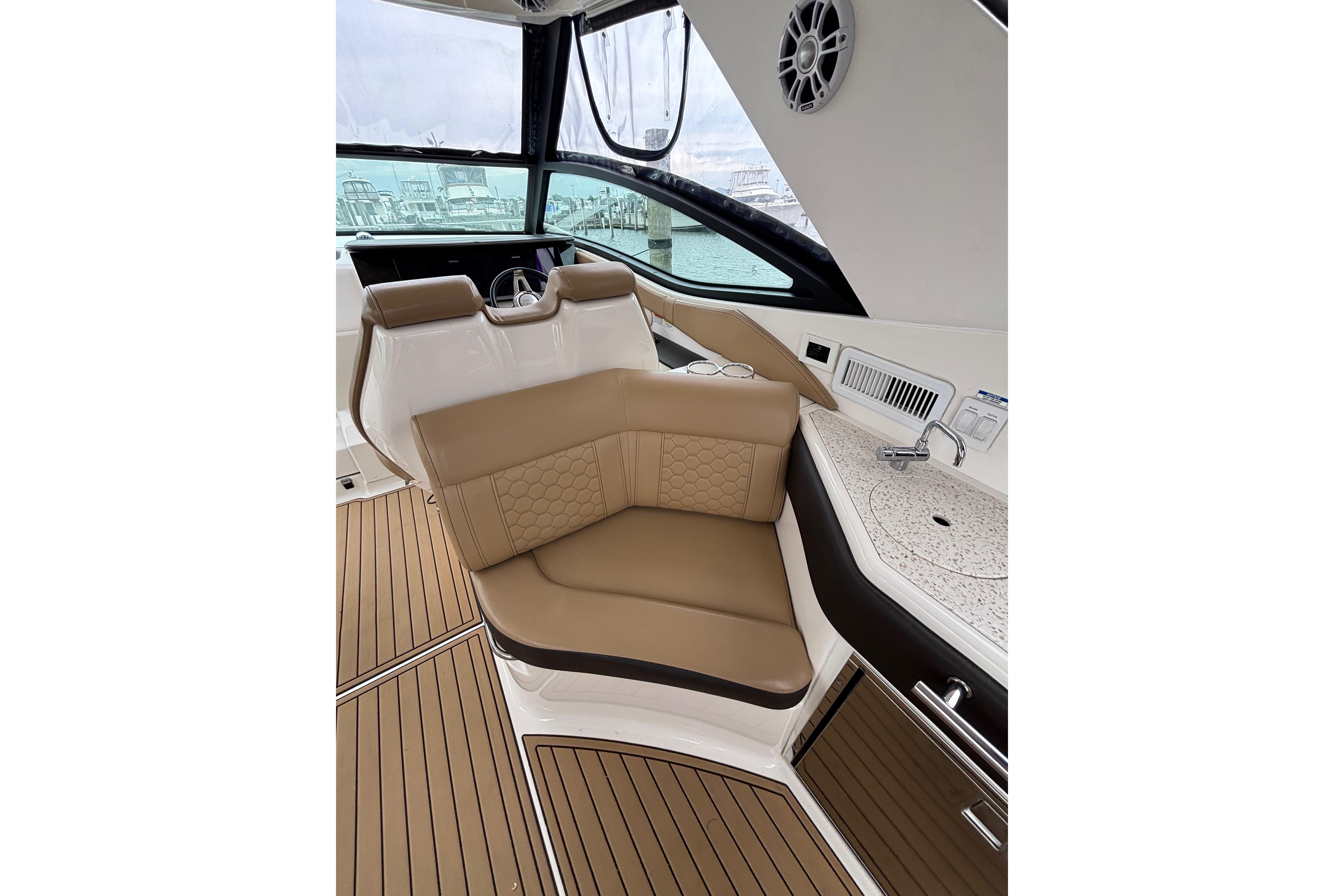Luxurious interior of 2021 Sea Ray Sundancer 320 Outboard with tan seating and modern amenities.