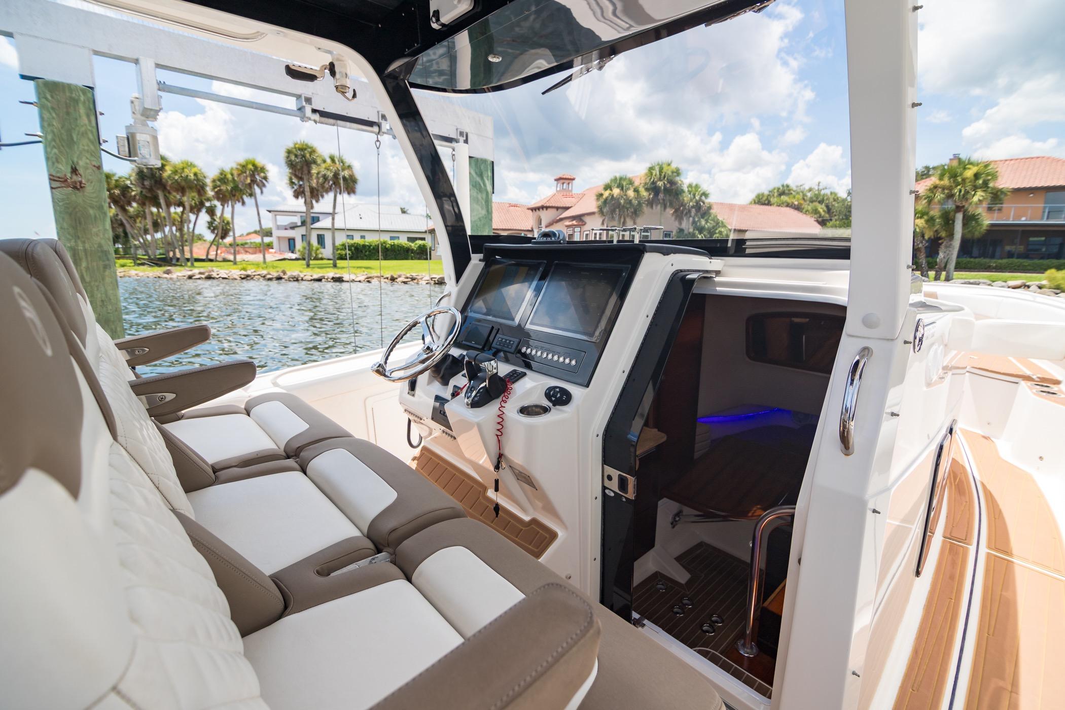 2016 Edgewater 368CC boat interior with helm, seating, and waterfront view.