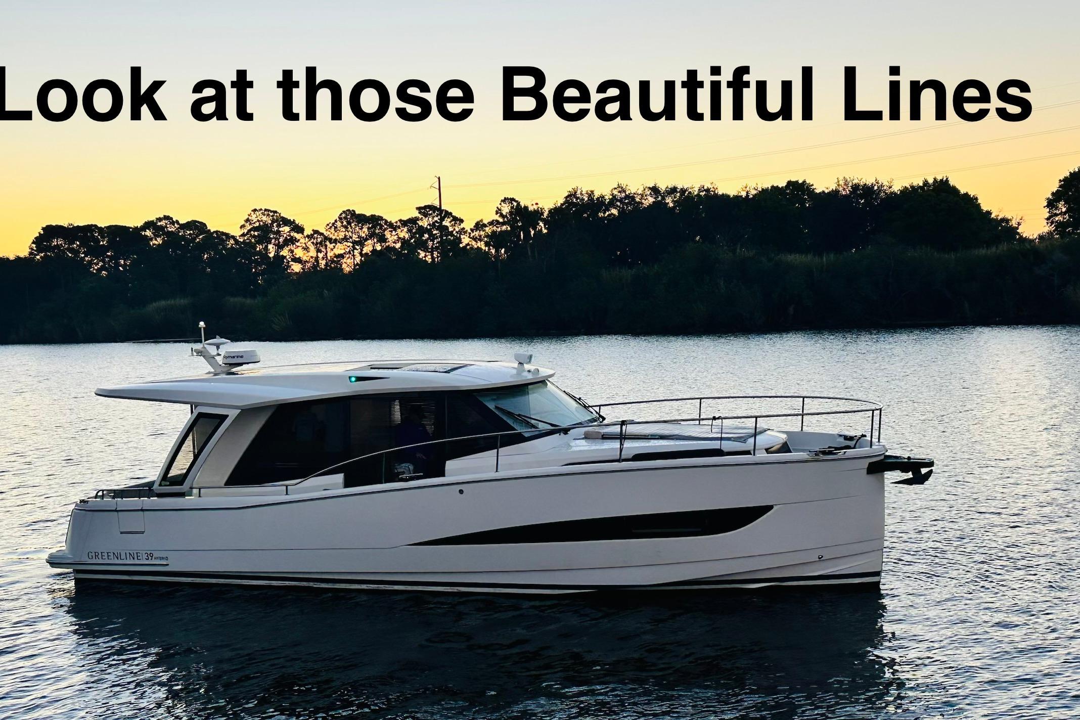 2021 Greenline 39 Hybrid yacht on serene water at sunset, showcasing sleek design.
