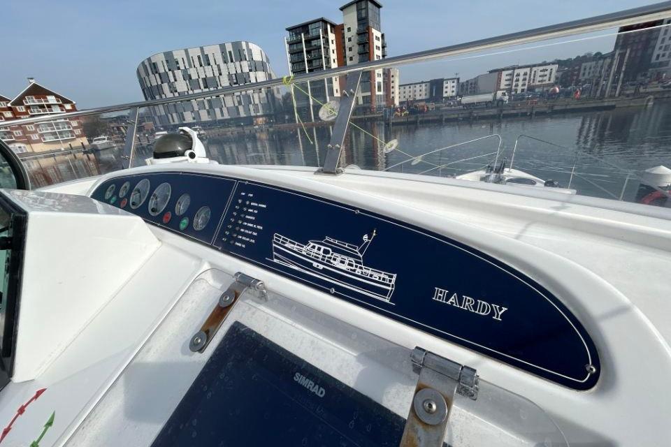 Control panel of a 2005 Hardy Commodore 50 yacht docked in a modern marina.