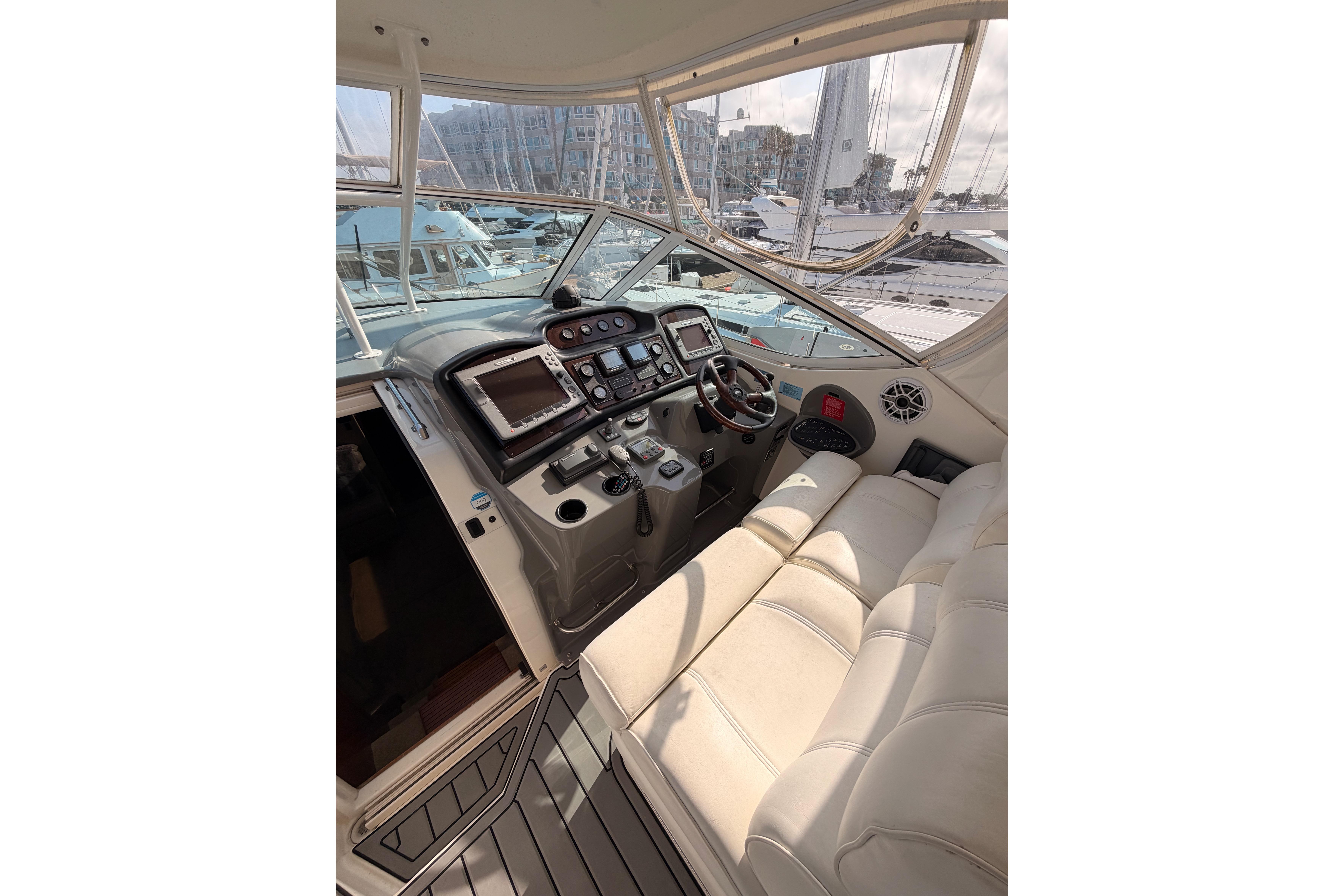 2005 Cruisers Yachts 405 Express Motoryacht helm with modern controls and plush seating.
