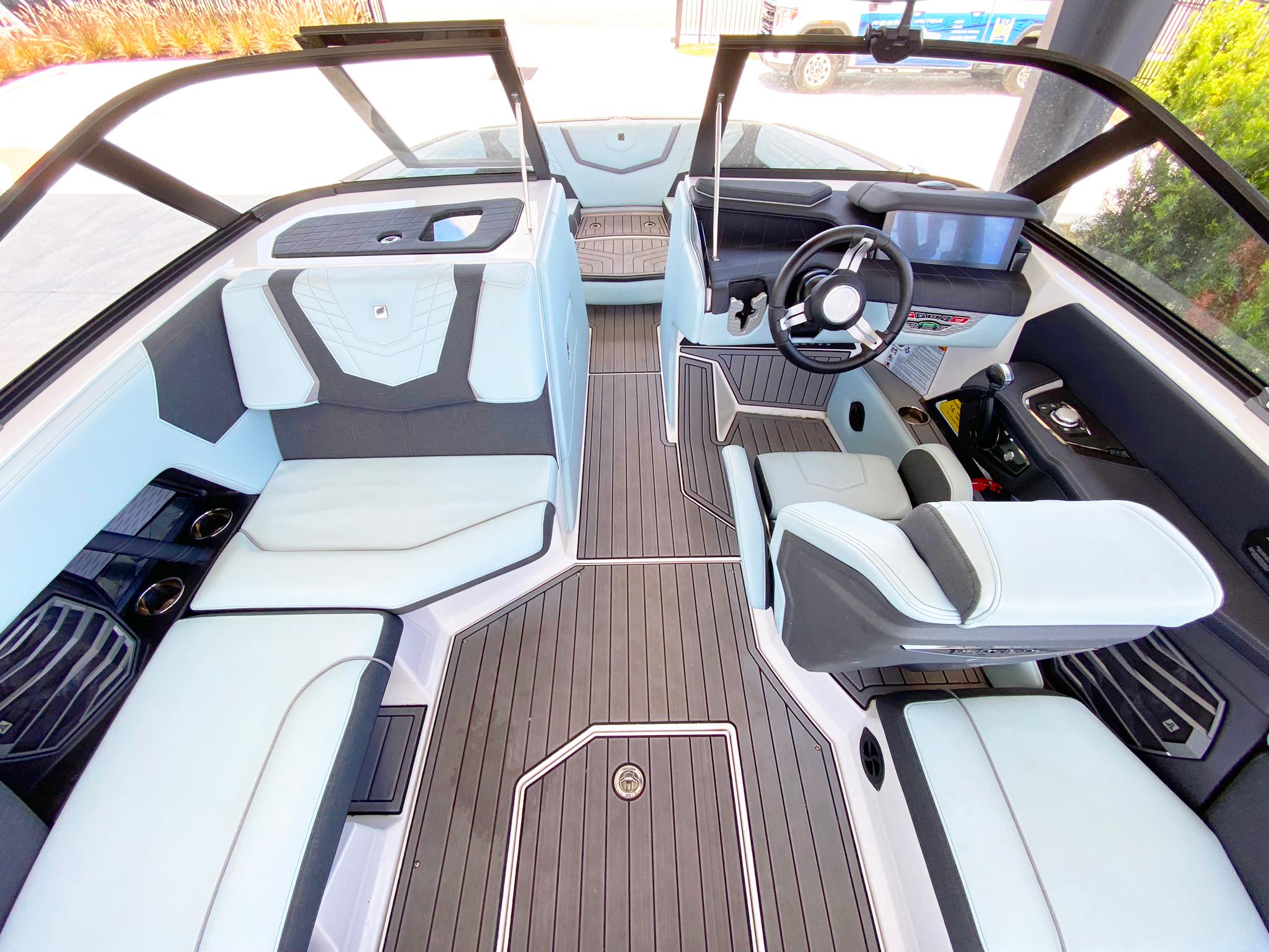 2024 Nautique Super Air Nautique G21 interior with sleek seating and modern dashboard design.