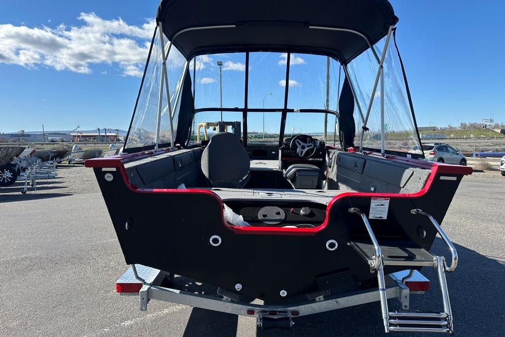 2026 Starweld 17 SXT boat with canopy, parked on a sunny day.