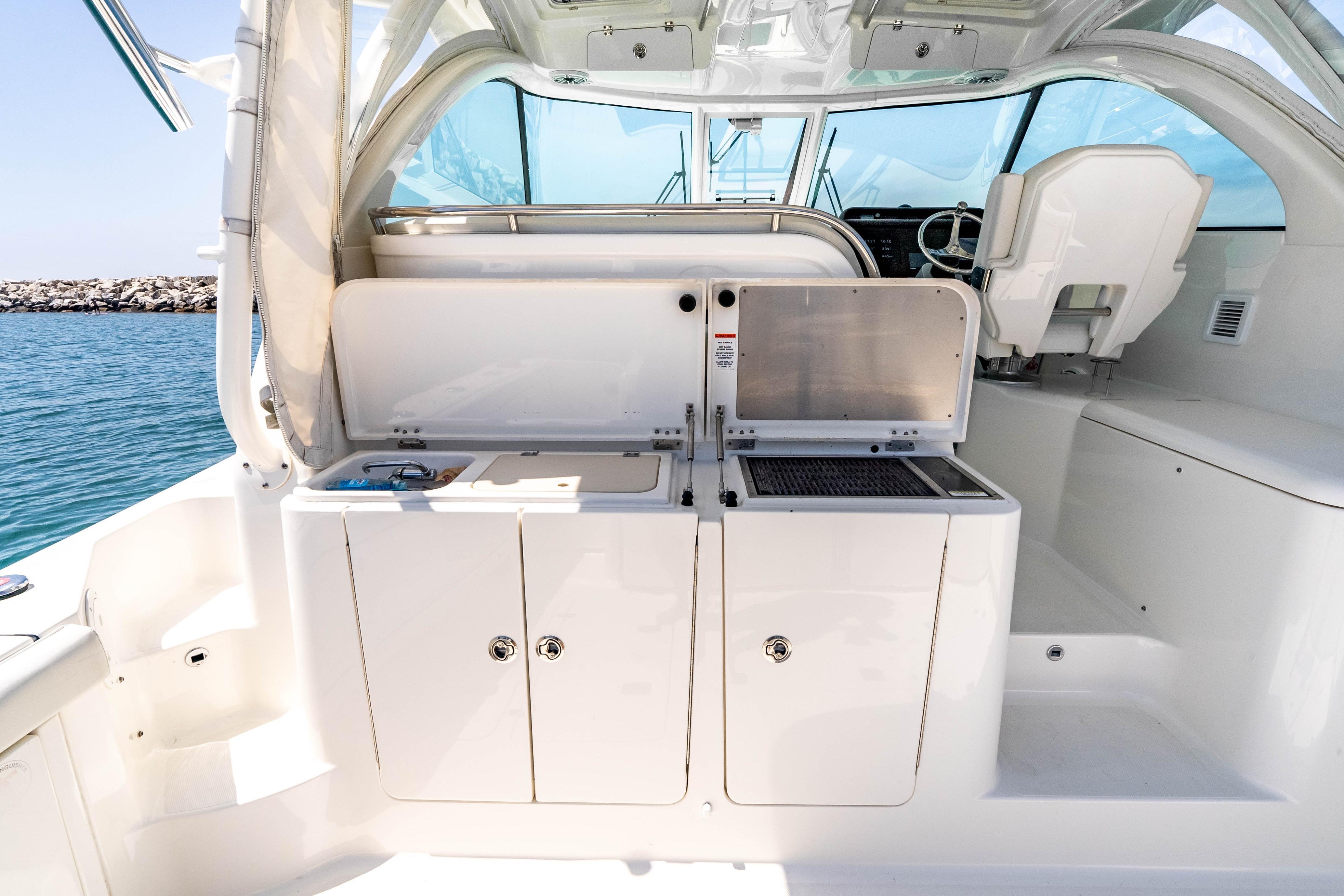 2022 Pursuit OS 385 Offshore boat interior with open storage compartments and seating.