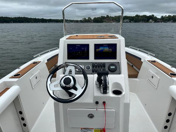 2025 Starcraft SVX 211 OB CC boat dashboard with dual screens on a lake.
