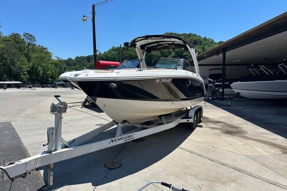 2012 Chaparral 284 Sunesta boat on trailer in sunny outdoor setting.