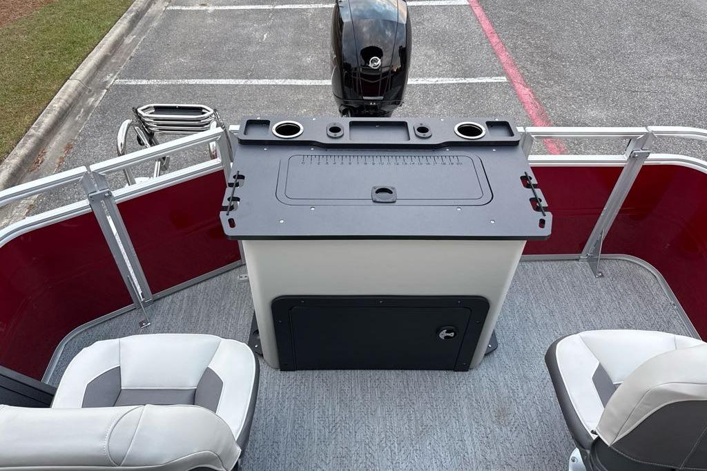 2026 Sun Tracker Fishin' Barge 22 DLX interior with seating and fishing station.
