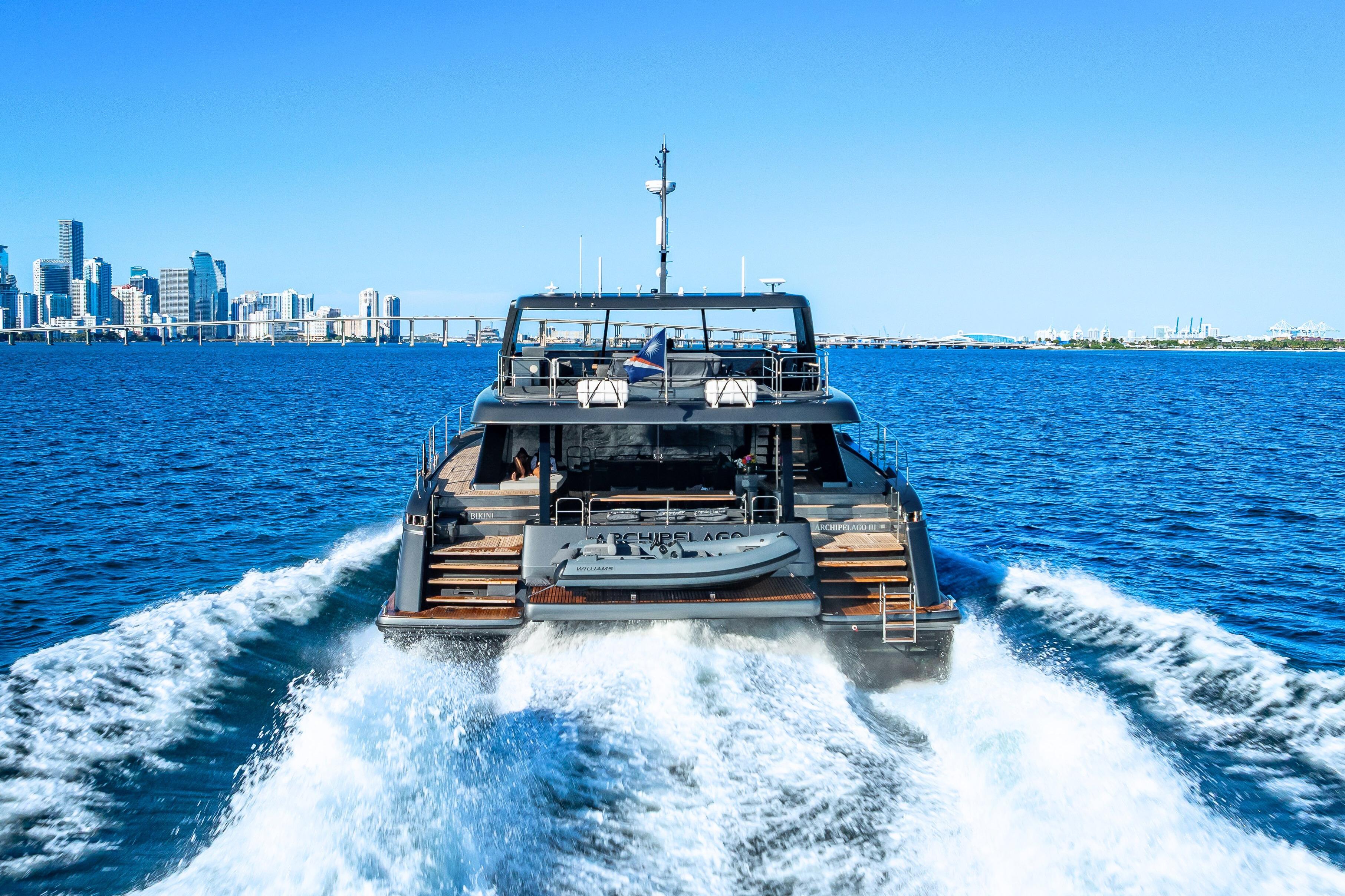 Sunreef 60 Power yacht cruising near city skyline, 2026 model.