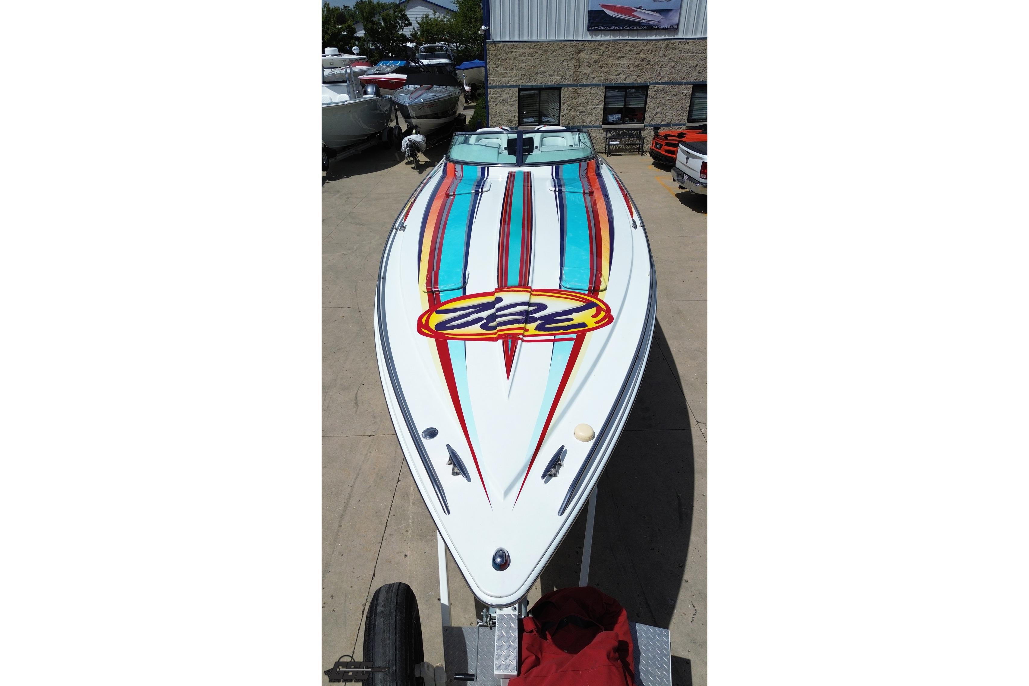 2002 Formula 382 FASTech speedboat with vibrant striped design on display.