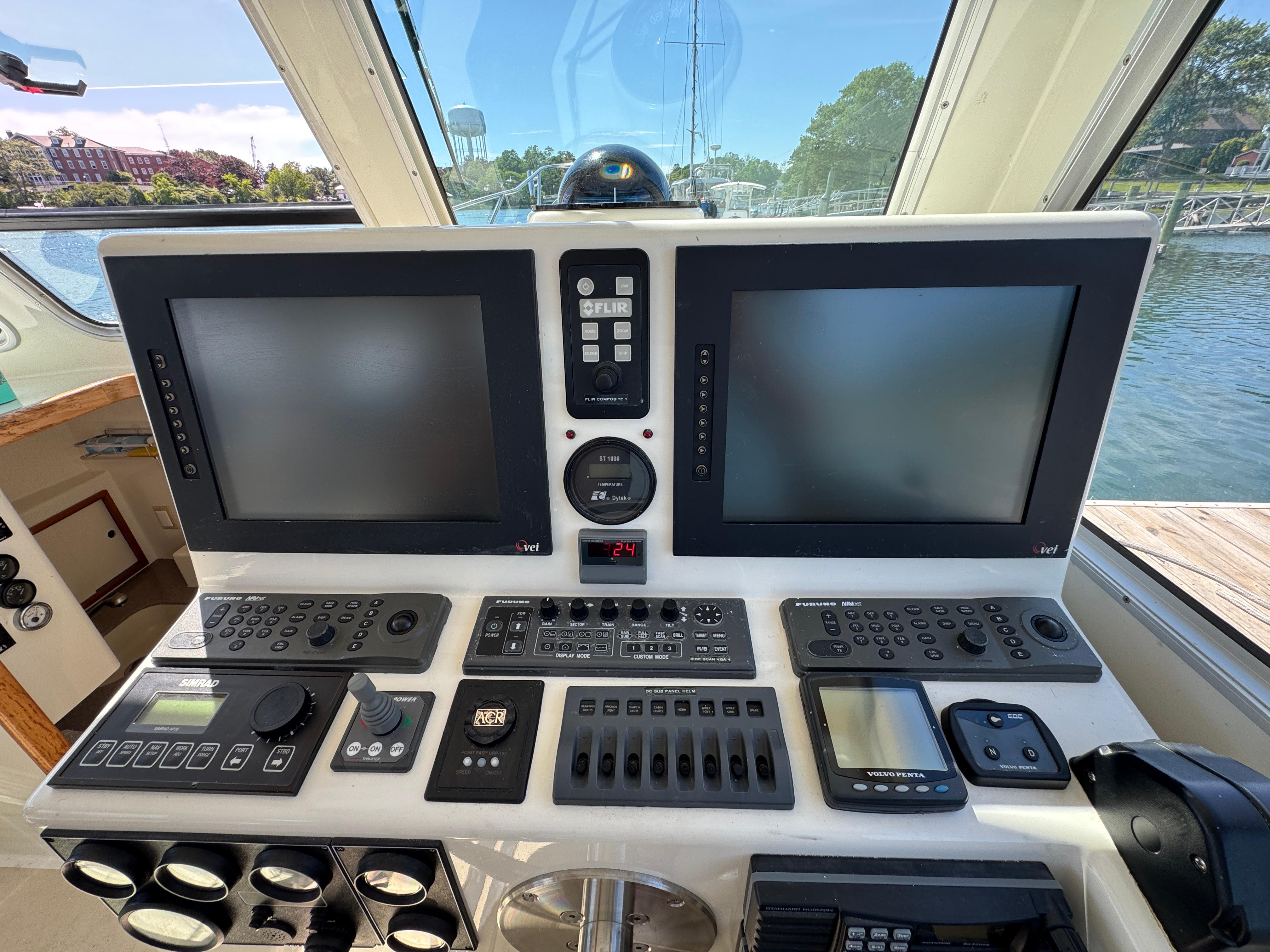 Control panel of a 2009 Northern Bay 36 boat with navigation screens and instruments.