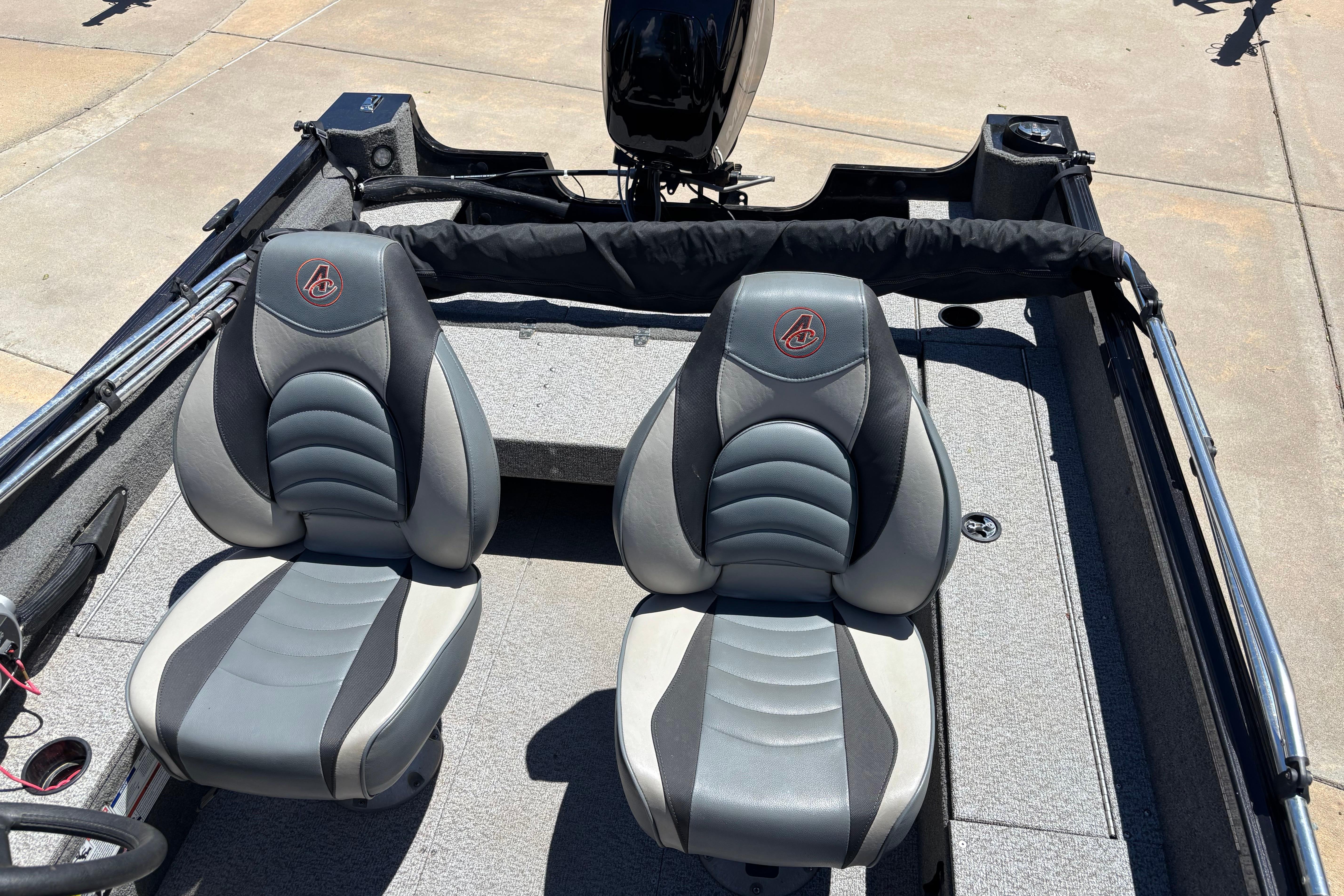 2021 Alumacraft Classic 165 boat interior with two gray seats and motor.