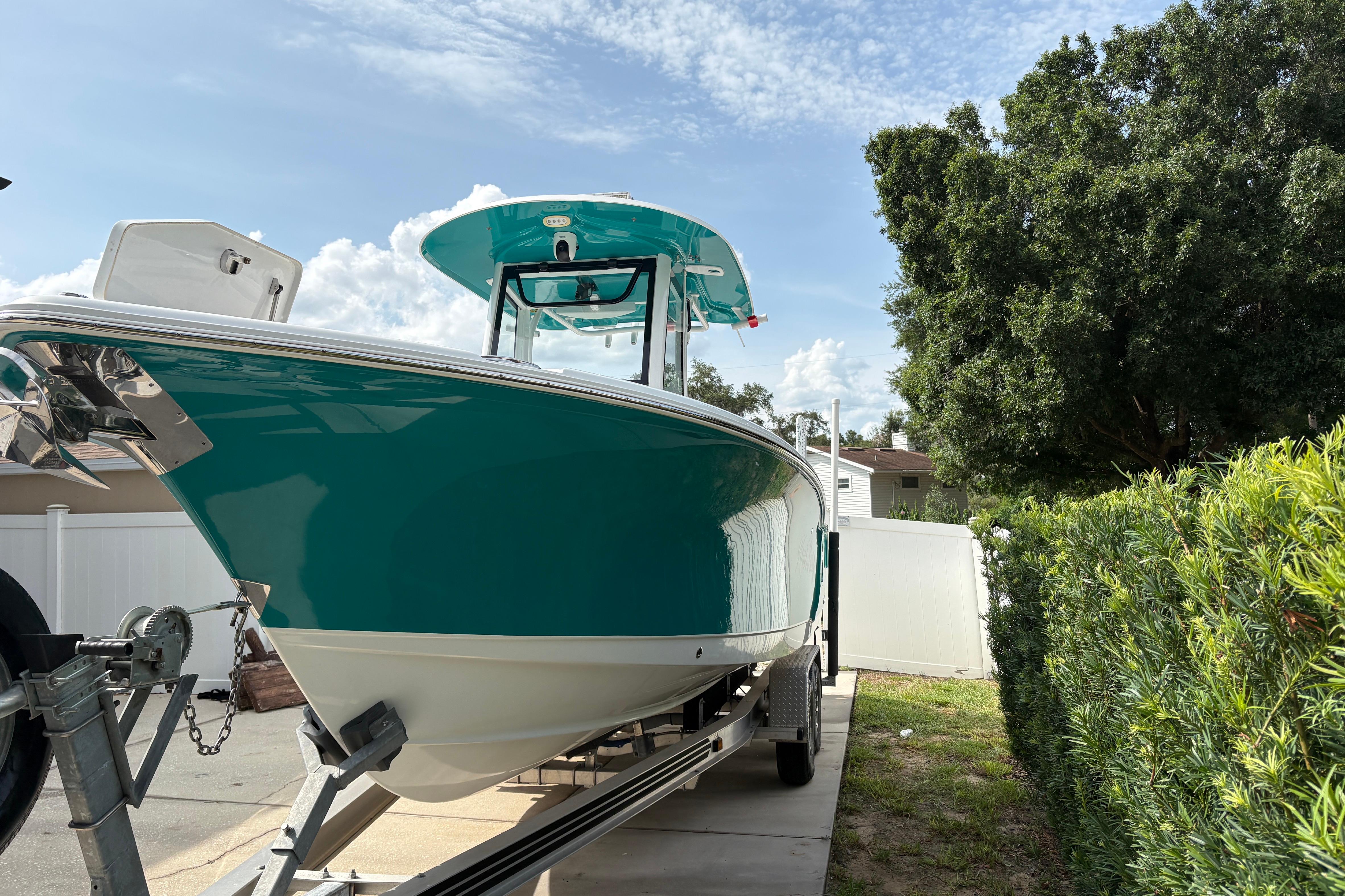 2021 Sea Hunt Ultra 265 SE boat on trailer, parked outdoors.