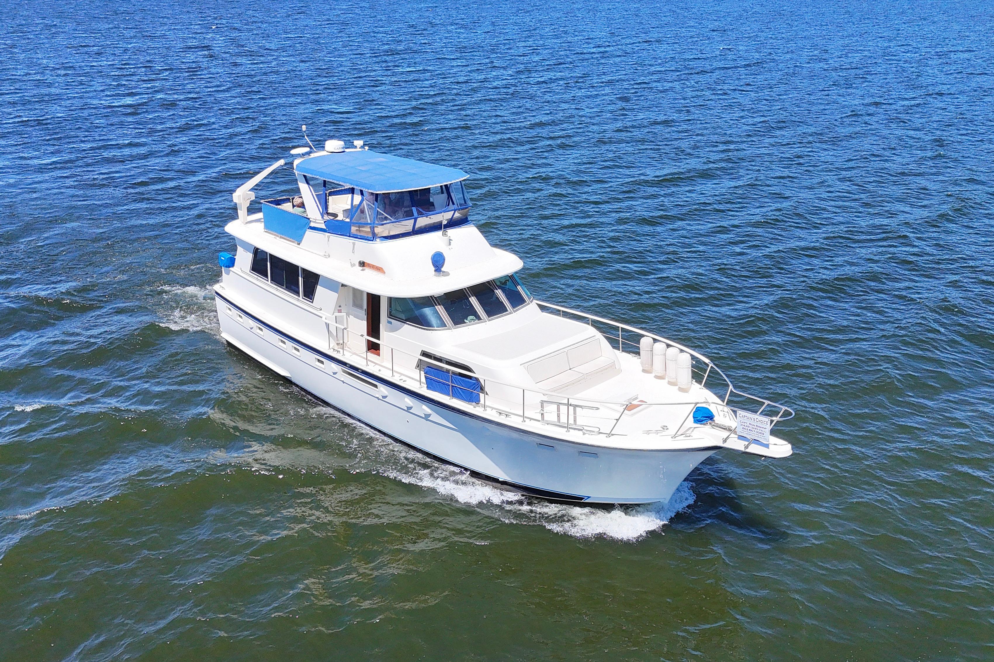 1984 Hatteras 53 Extended Deckhouse Motor Yacht cruising on open water.