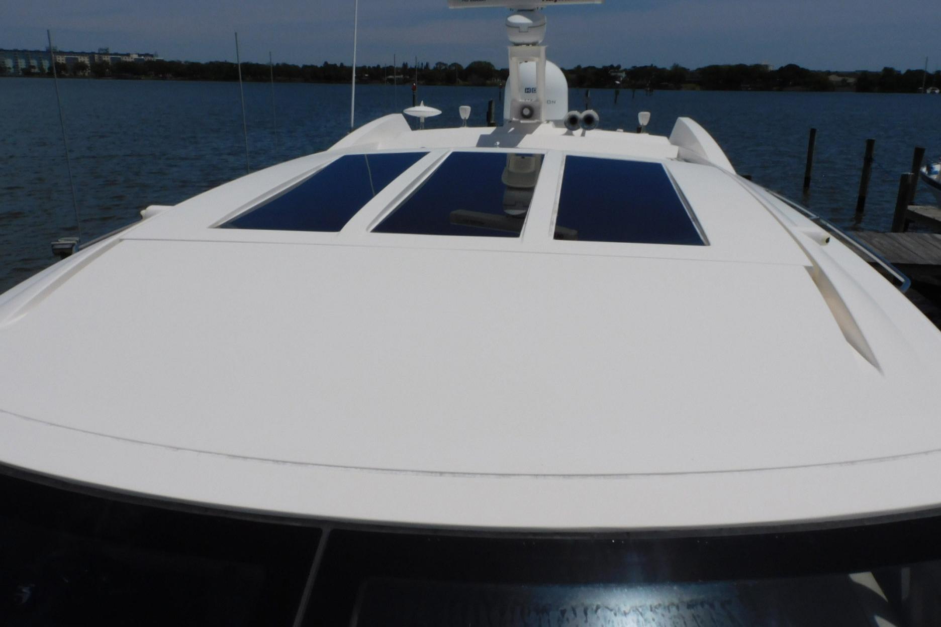 2019 Sea Ray L550 yacht with sleek design and panoramic windows on calm water.
