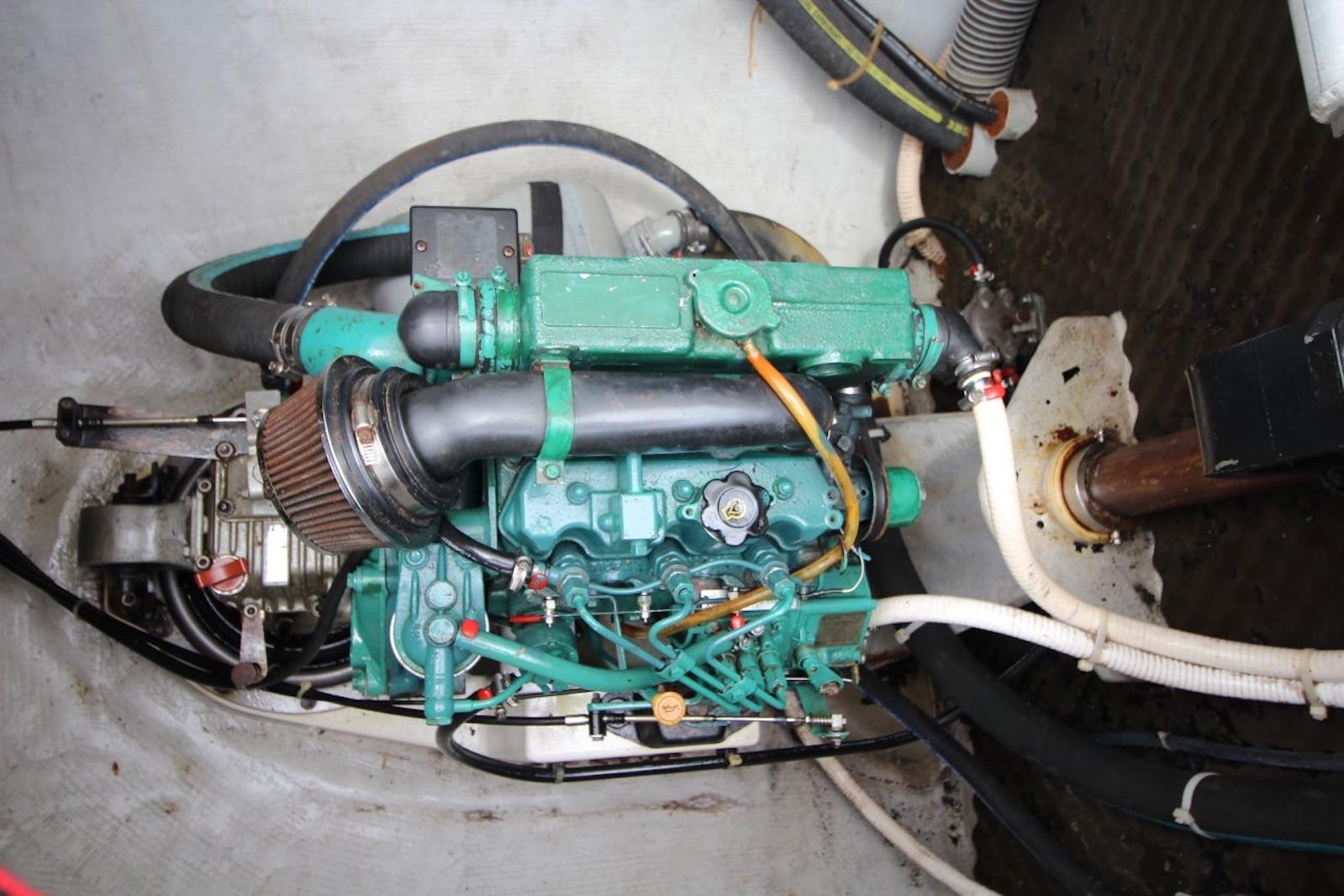 Engine compartment of a 2004 Lagoon 380 catamaran, showcasing mechanical components and hoses.