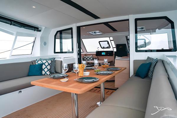 Luxurious interior of 2025 Nautitech 40 Open catamaran with elegant dining setup.