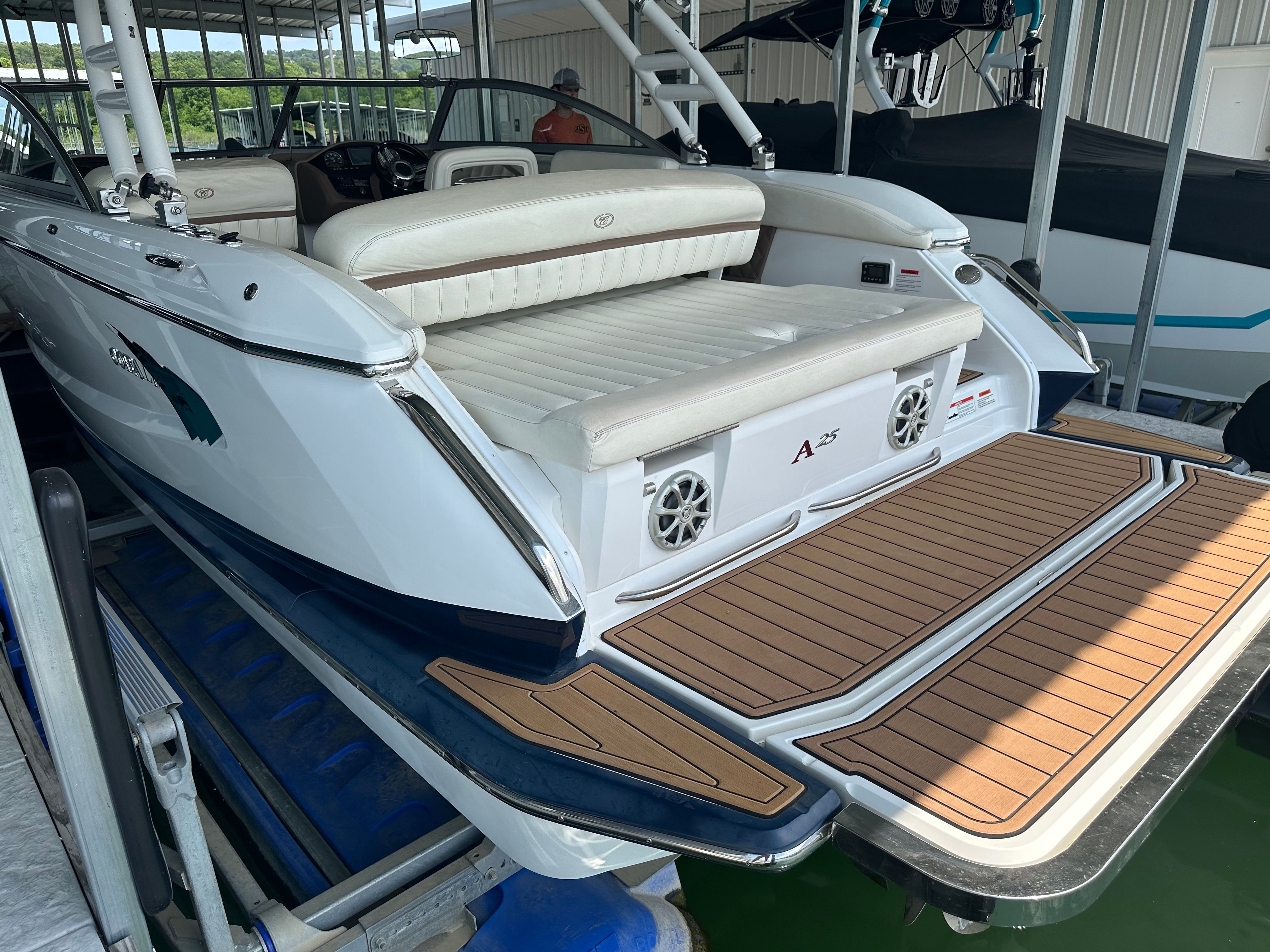 The image shows a 2011 Cobalt A25 boat with a spacious swim platform and white upholstery.