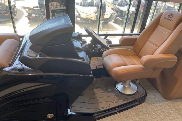 Luxurious 2026 Regency 230 DL boat interior with plush captain's chair and sleek dashboard.