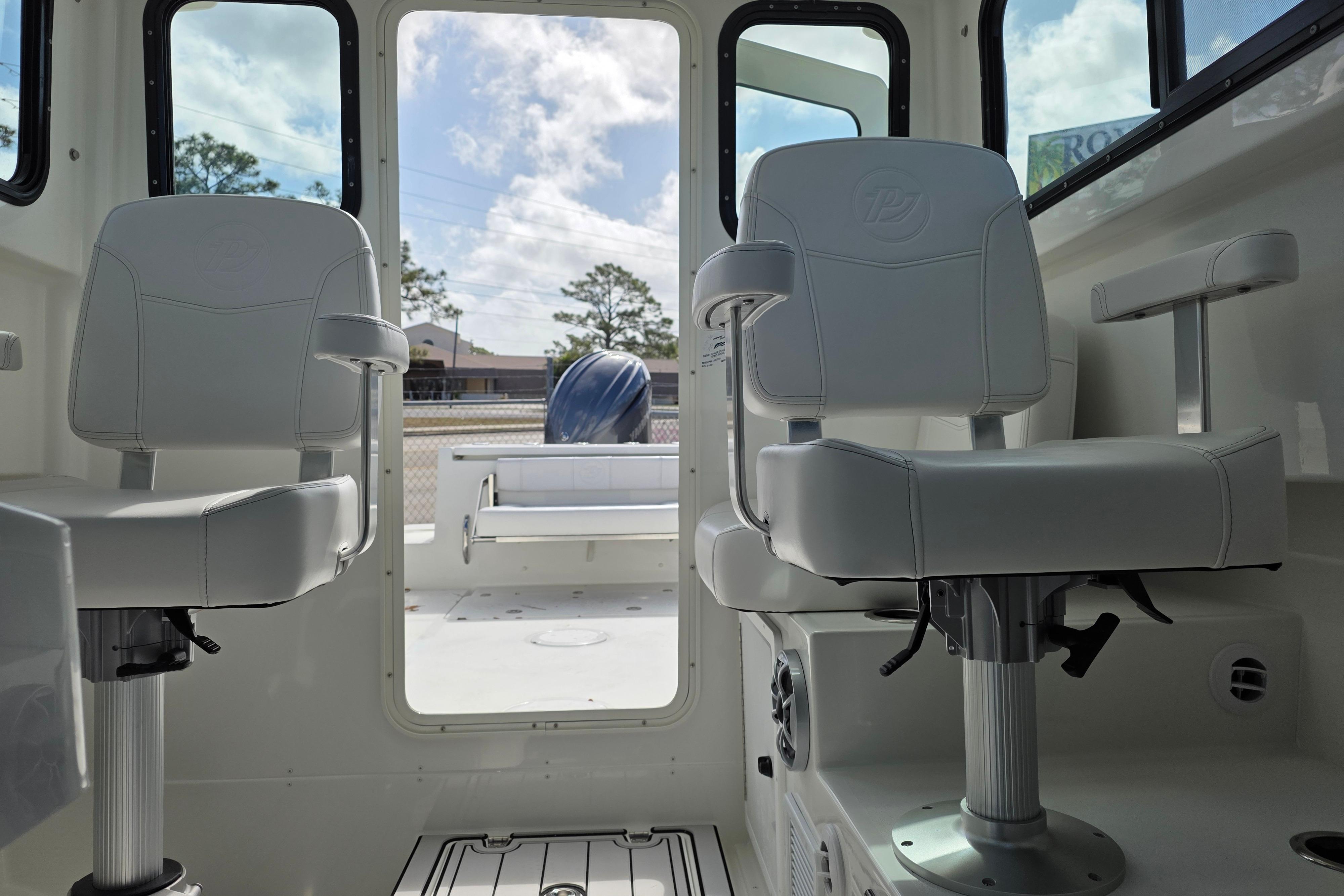 Interior of 2026 Parker 227 Explorer boat with two swivel seats and open rear view.