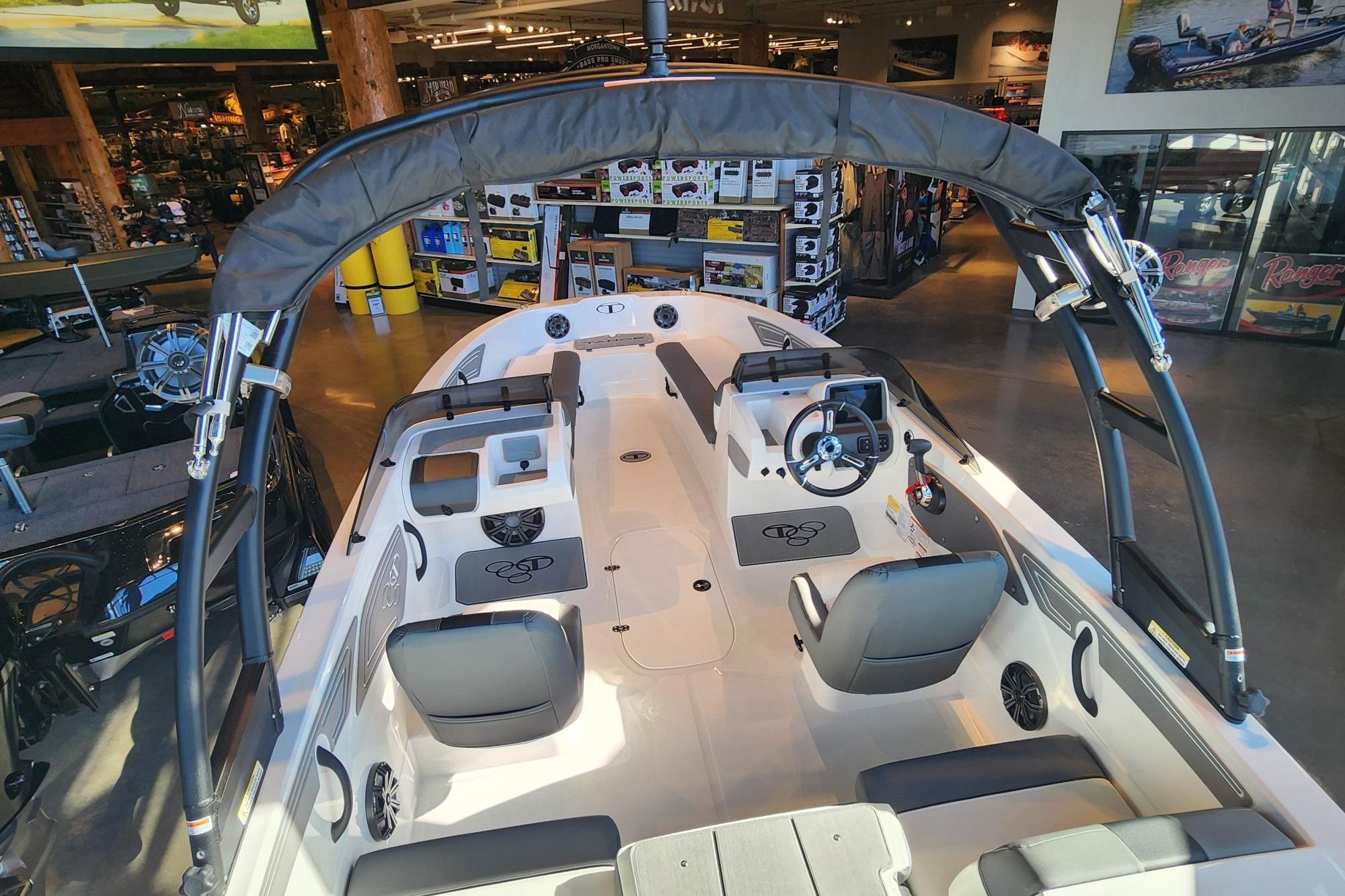 2026 Tahoe T21 boat interior with seating and steering wheel in showroom.