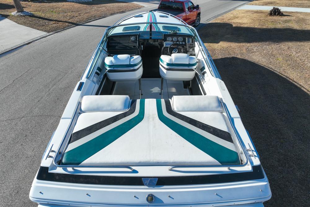 1989 Formula 292 SR-1 boat with striped upholstery, parked on a street.