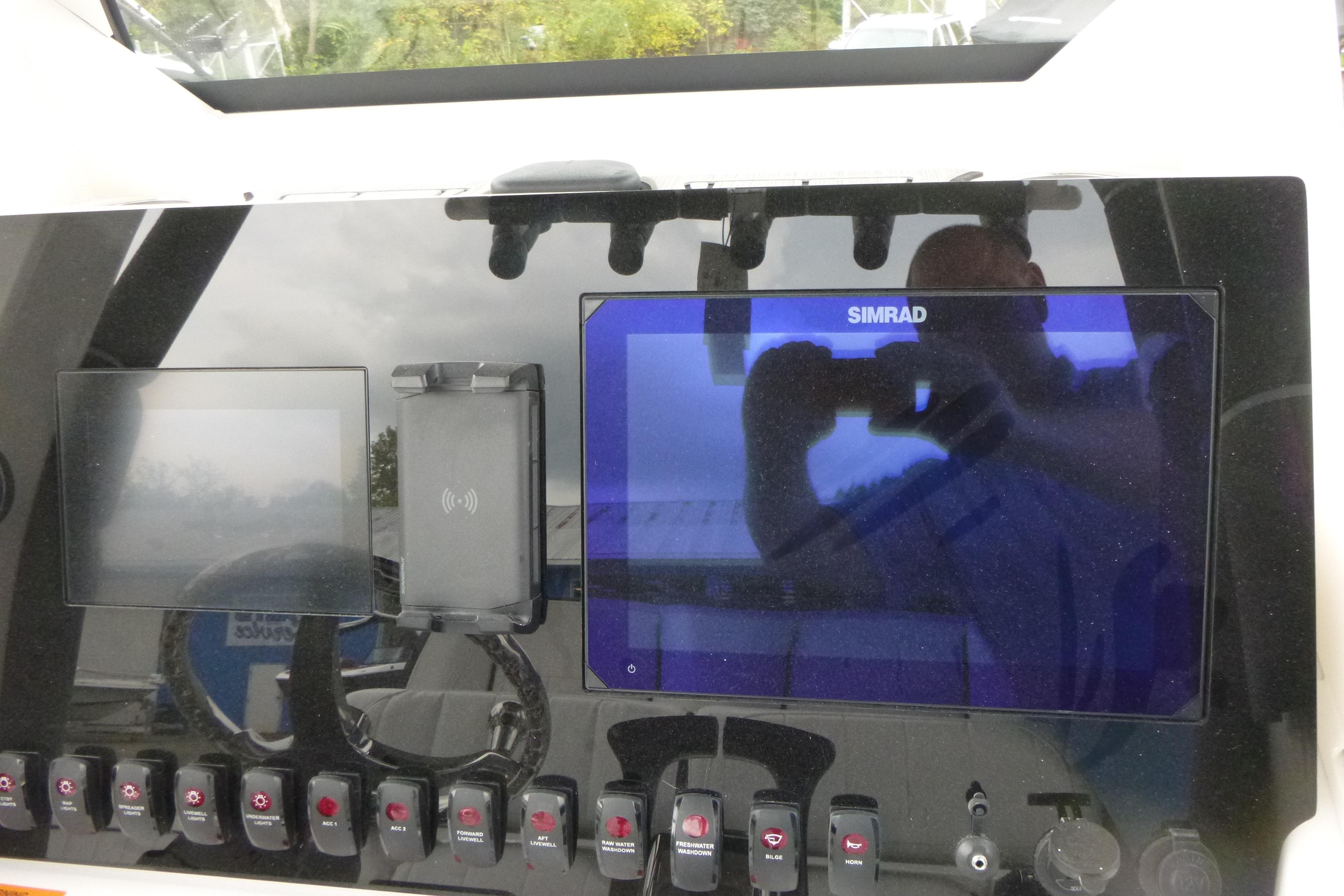 Control panel of 2026 Yamaha Boats 255 FSH Sport H with Simrad display and switches.