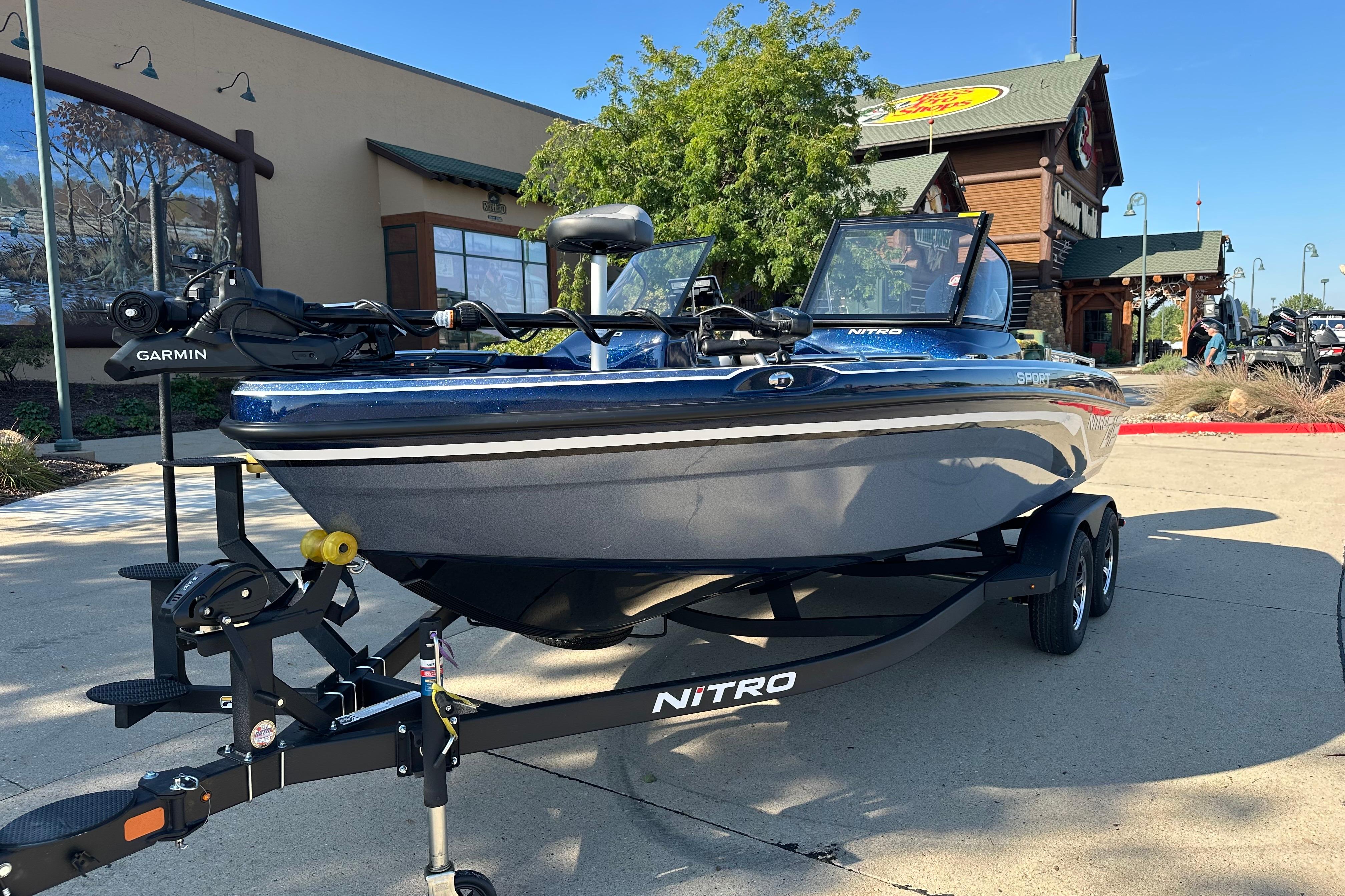 2026 Nitro ZV19 Sport Pro boat on trailer outside a store.