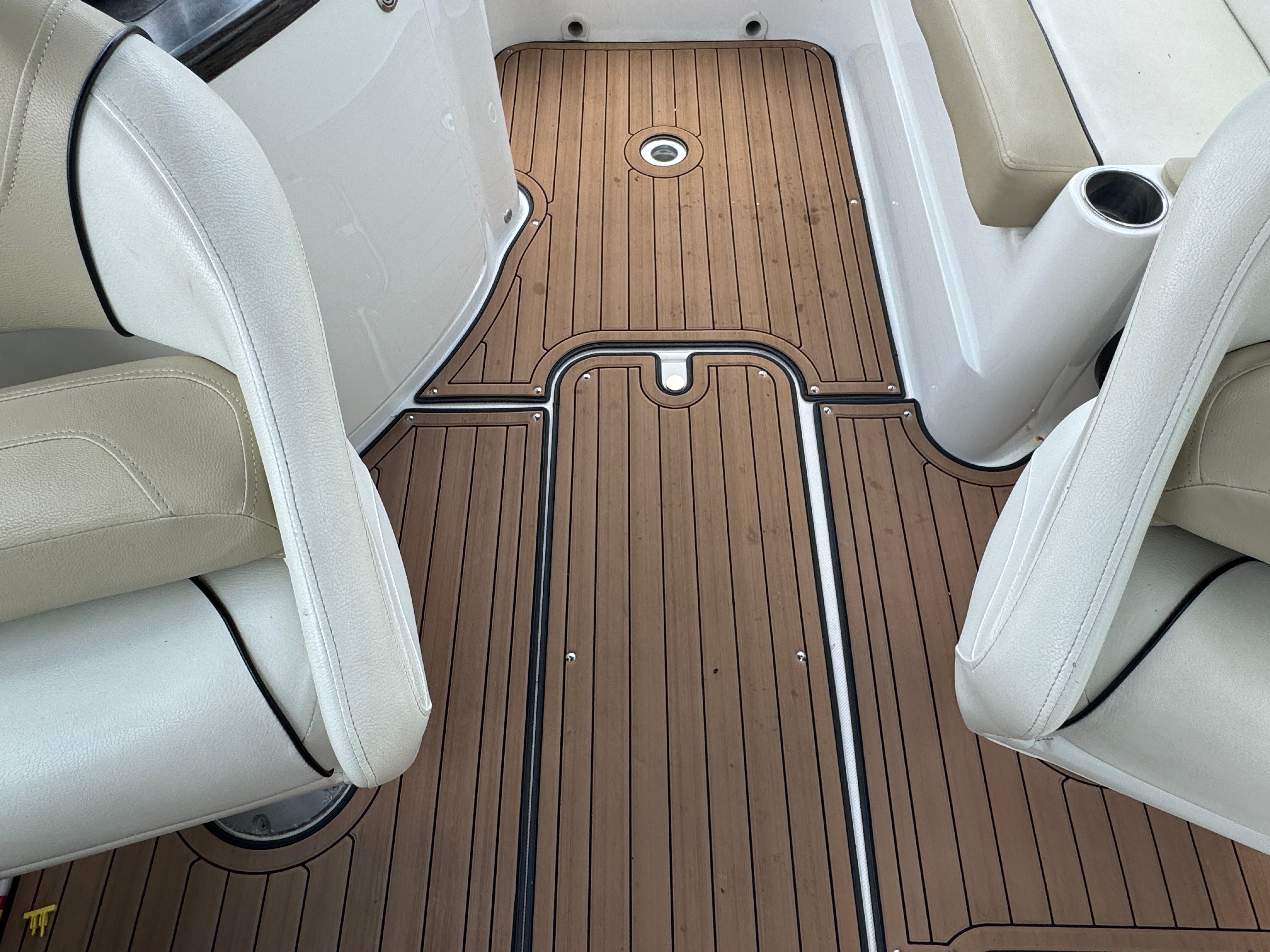 Interior of a 2017 Rinker QX29 BR with wooden flooring.