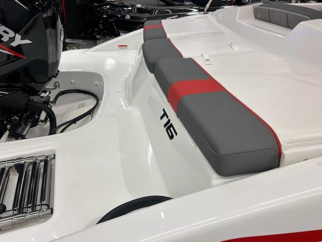 2025 Tahoe T16 boat interior with gray and red seating, featuring a Mercury engine.