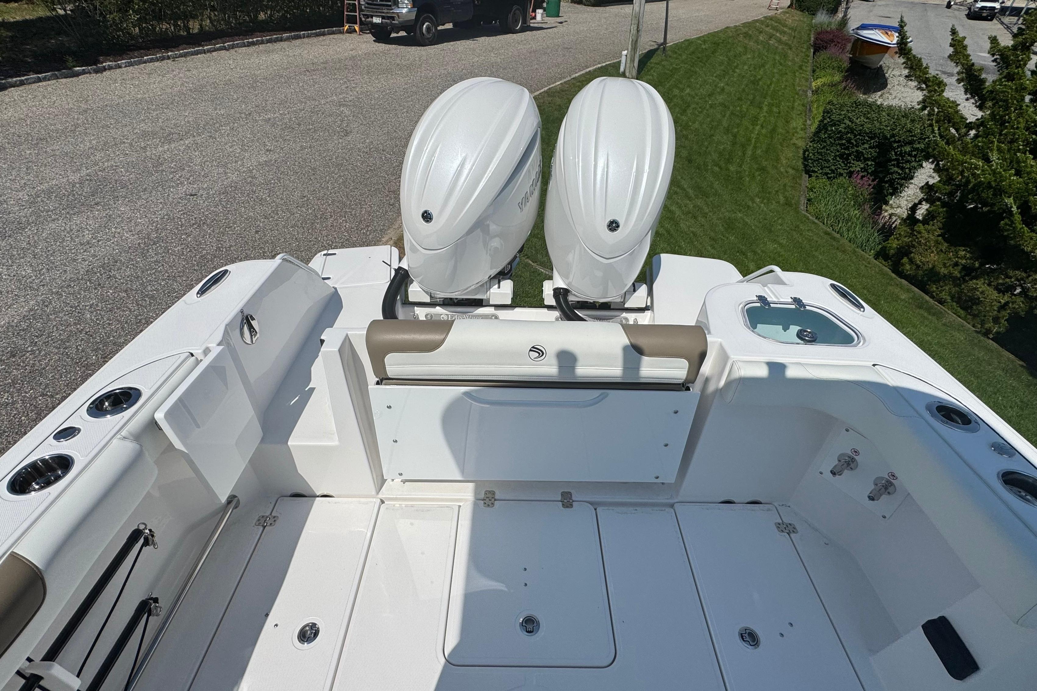 2026 Edgewater 250CC boat with dual outboard engines, spacious deck, and modern design.