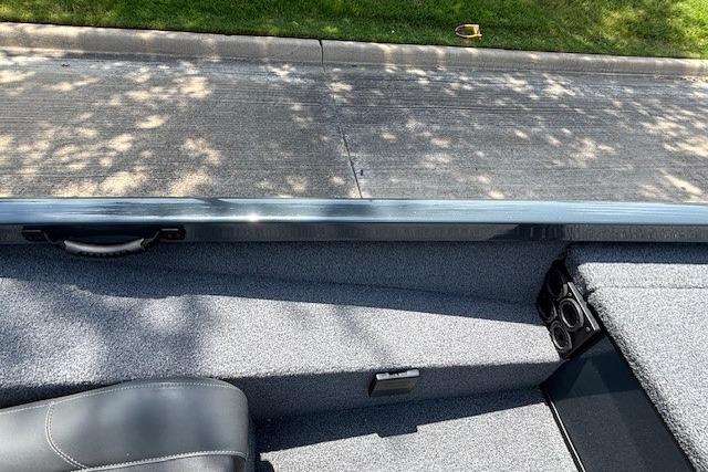 2026 Ranger RT188 boat interior with gray upholstery and cup holders, parked on a sunny street.