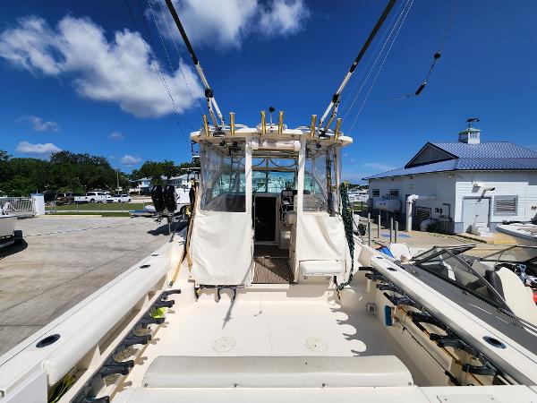 2005 Pursuit 3070 Offshore Center Console boat docked under clear blue sky.
