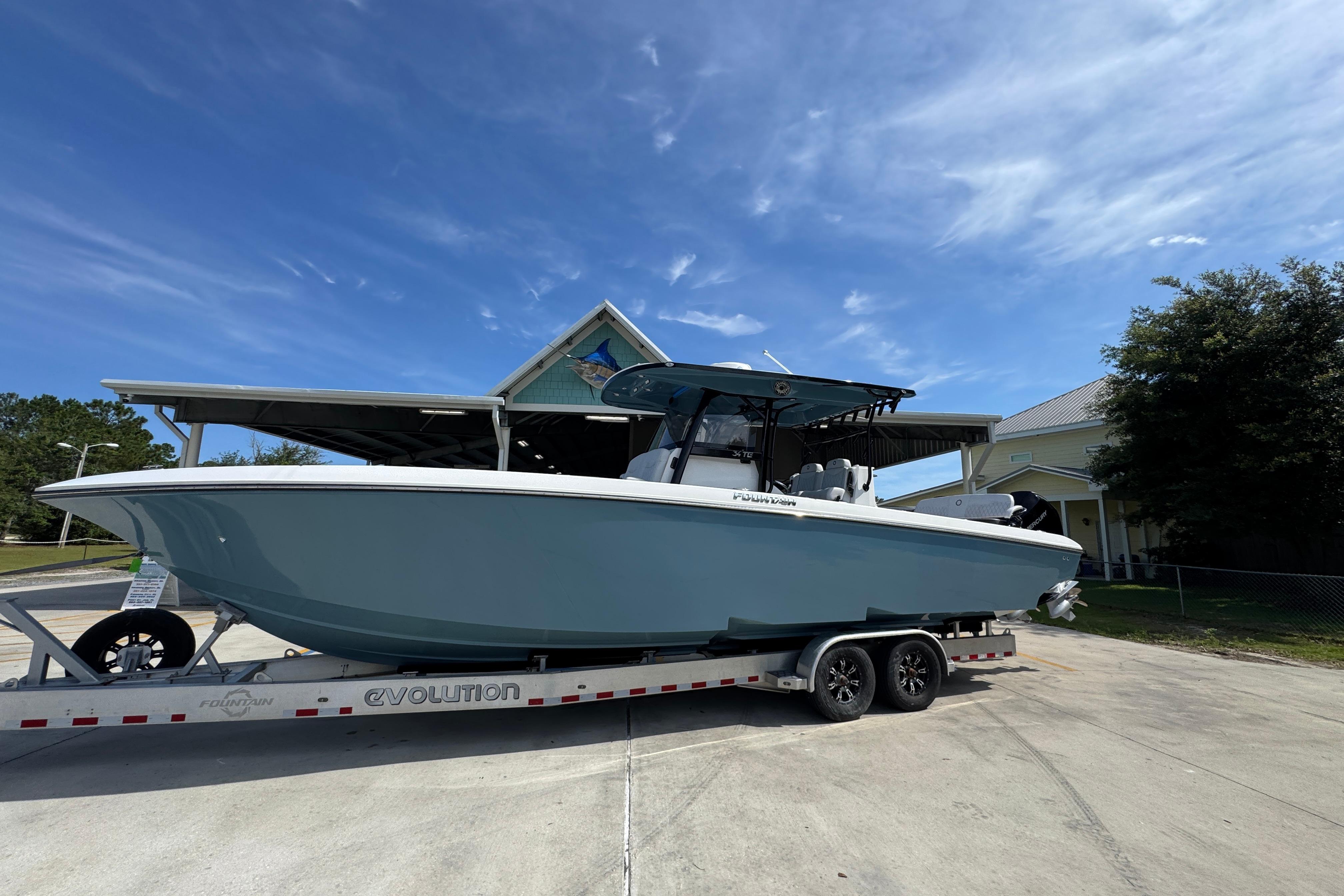 2023 Fountain 34 Tournament Edition boat on trailer under clear blue sky.