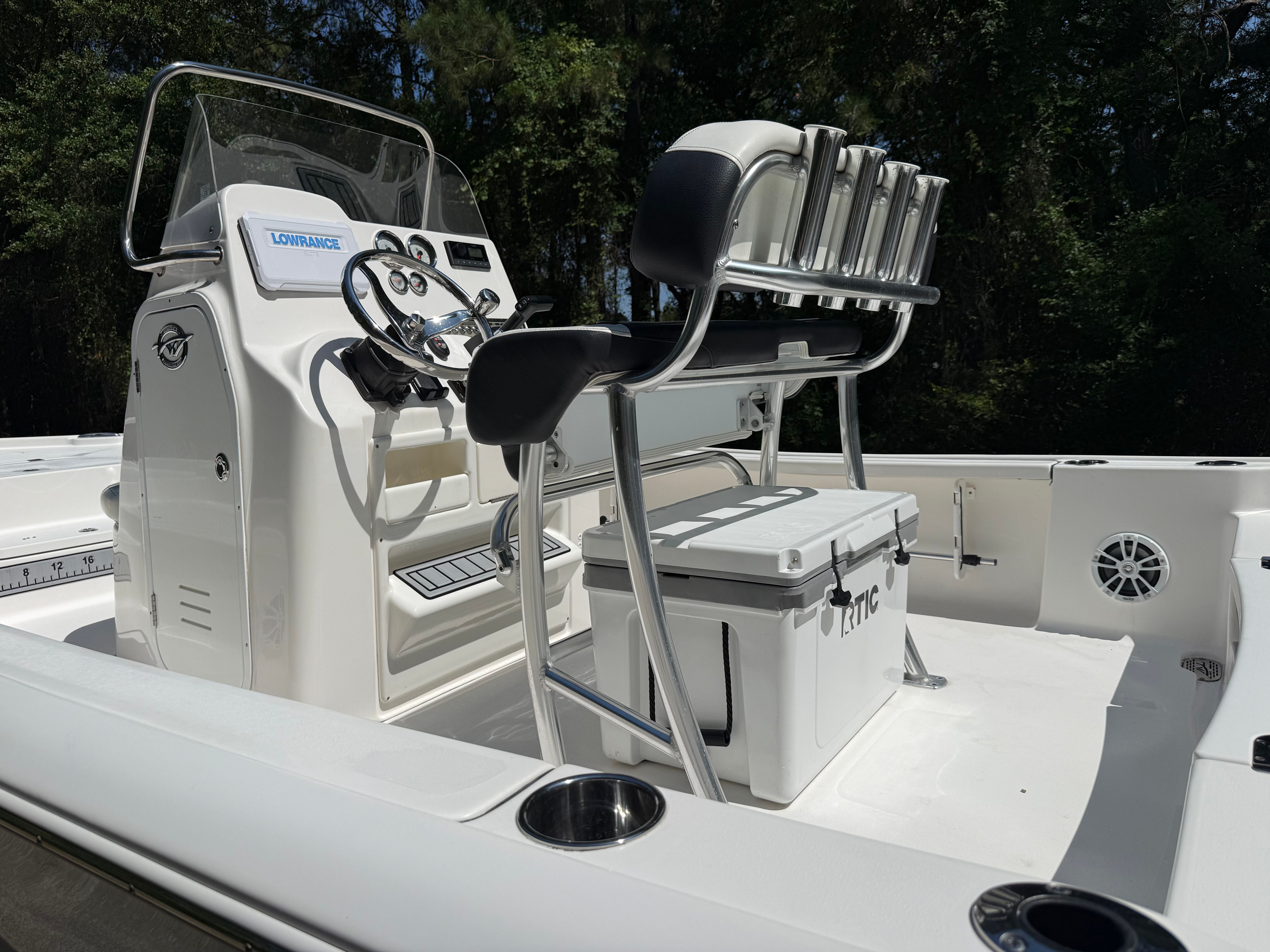 The image shows a 2023 Tidewater 2210 Carolina Bay boat with a helm console and seating.