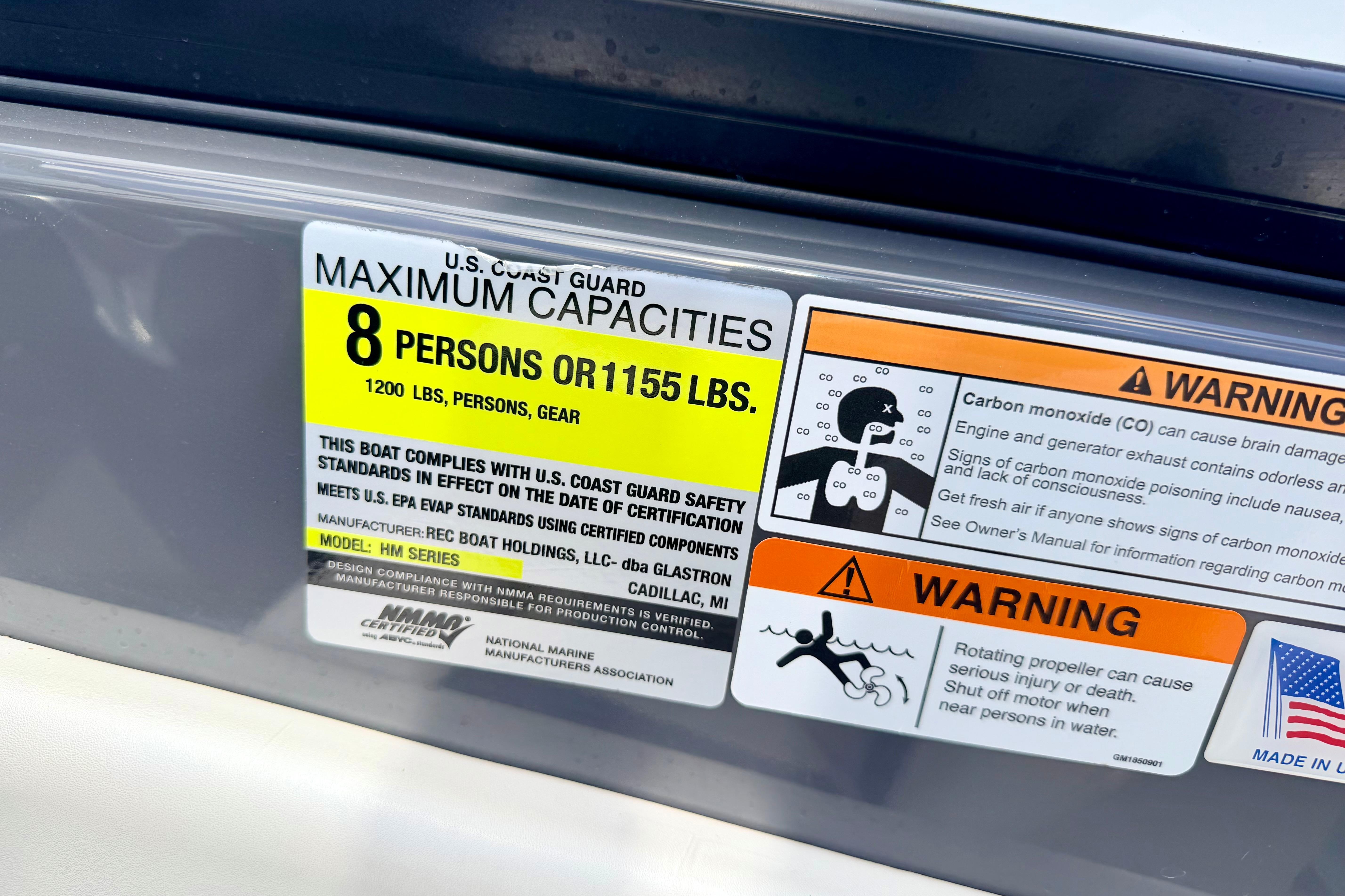 2018 Glastron GT 185 capacity label, warning for 8 persons or 1155 lbs, safety instructions.