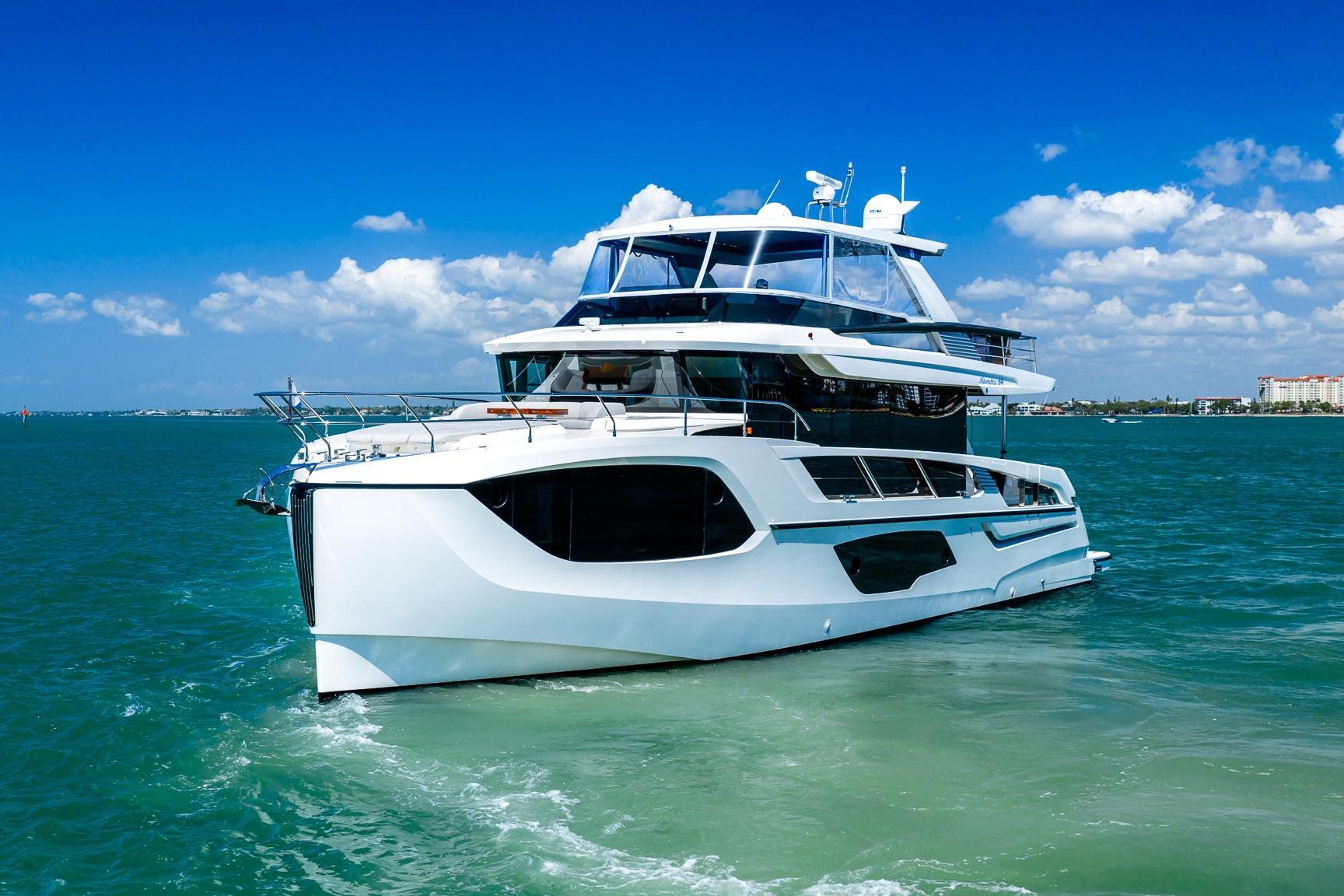 Luxurious 2022 Absolute 64 Navetta yacht cruising on clear blue waters.