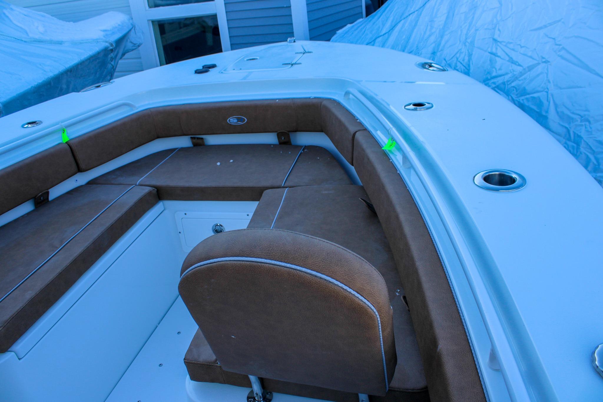 2026 Sea Hunt Gamefish 25 boat interior with brown seating and cup holders.