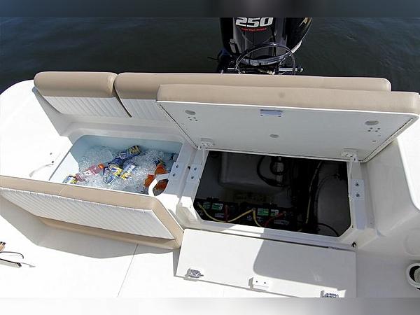 2023 Sea Born LX22 Center Console boat with open storage compartments and visible engine.