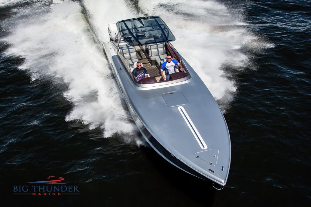 2019 Donzi 41 GT speedboat cruising on water, Big Thunder Marine logo.