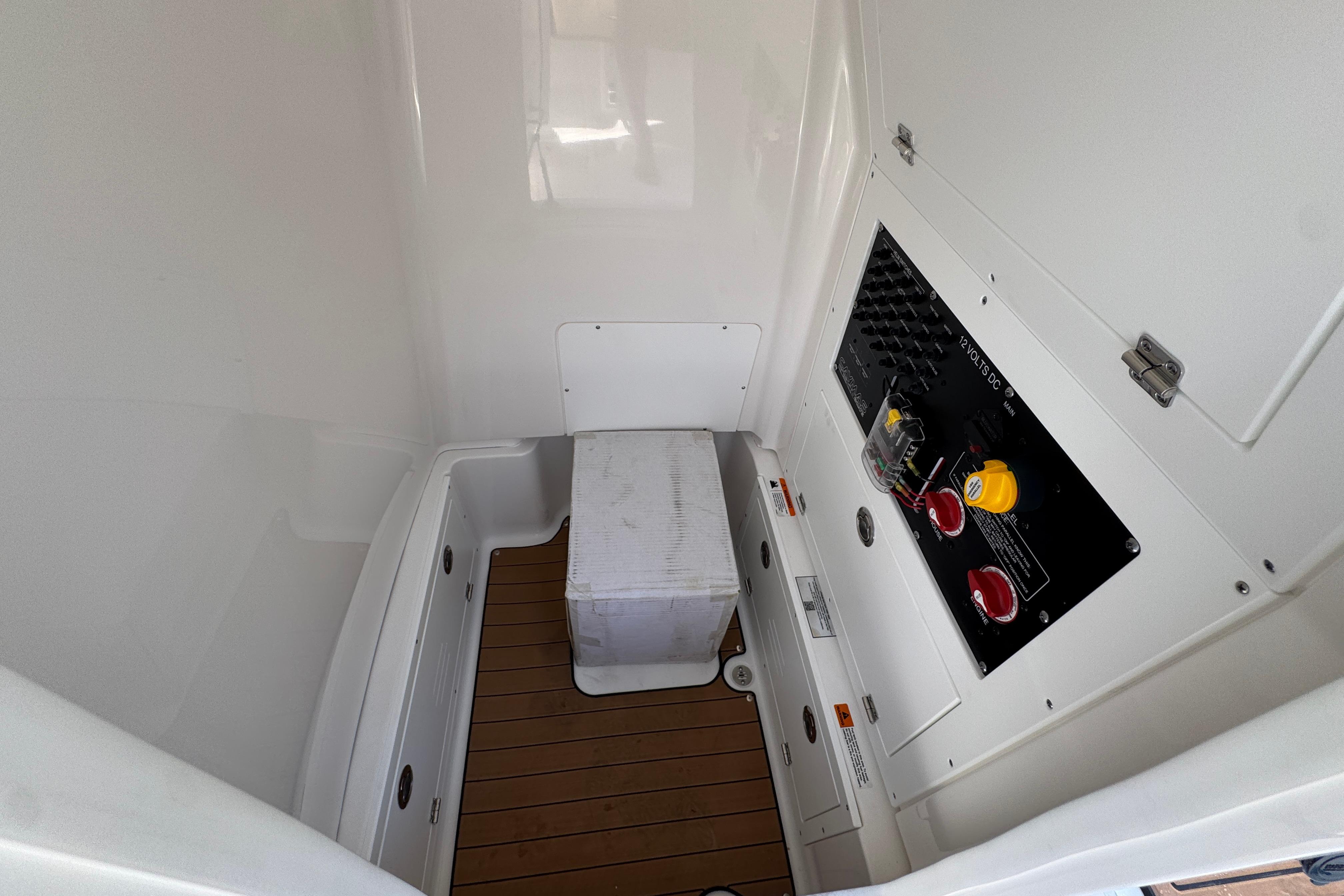 Interior of 2027 Caymas 26 HB boat featuring control panel and storage area.