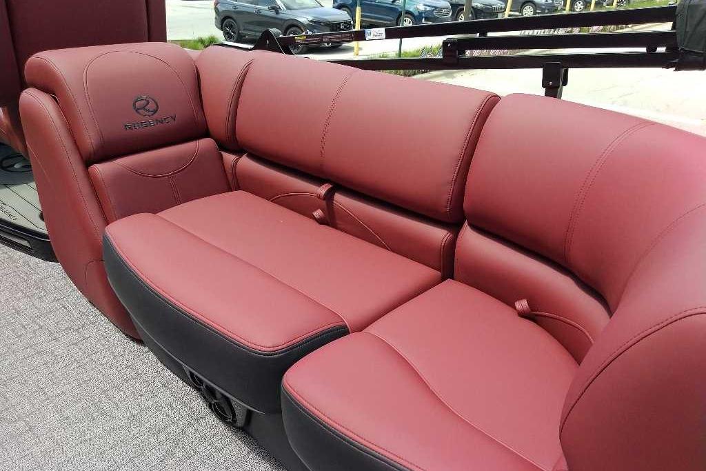Luxurious maroon seating in 2026 Regency 230 DL boat interior.