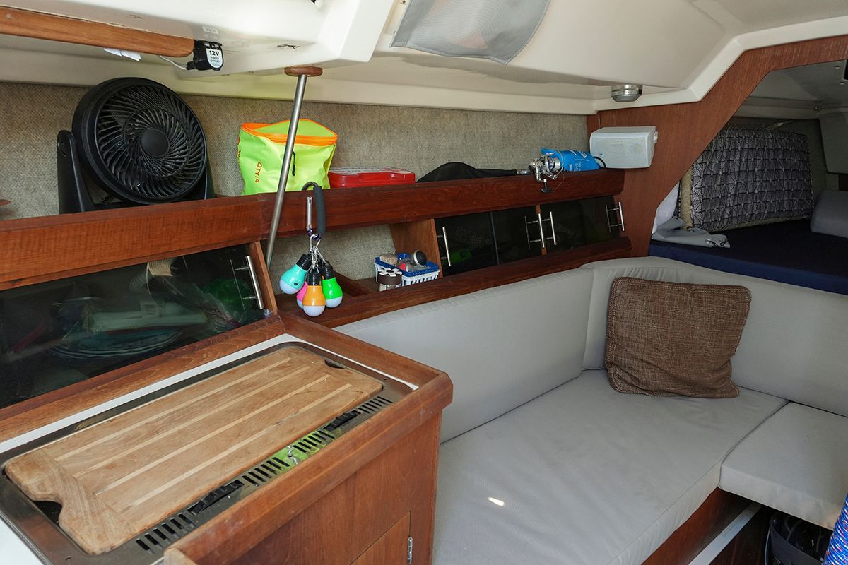 Interior of a 1985 Hunter 28.5 sailboat with cozy seating area.
