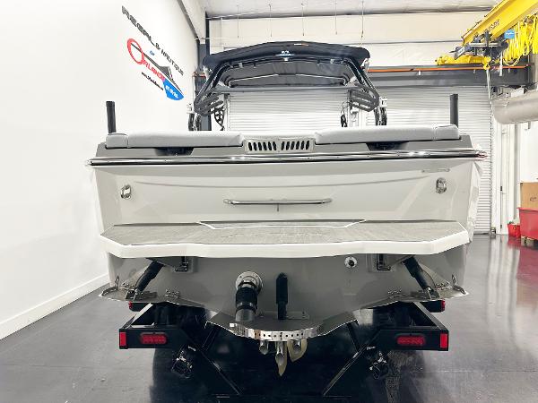 Rear view of 2025 Supreme S240 boat in a showroom setting.