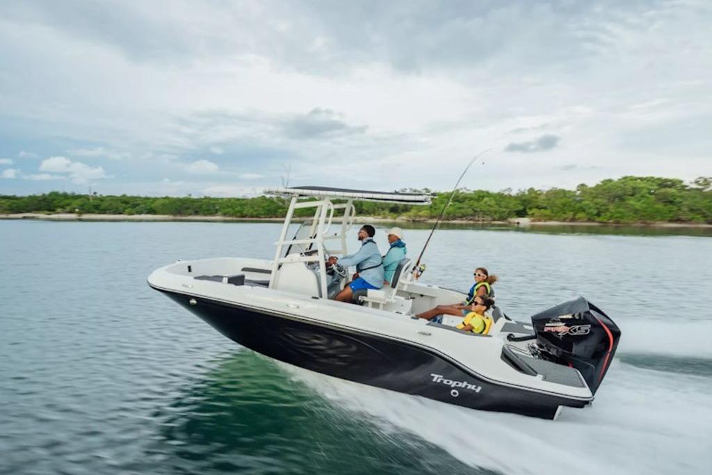 2026 Bayliner Trophy T20CC boat cruising on a scenic waterway with passengers.
