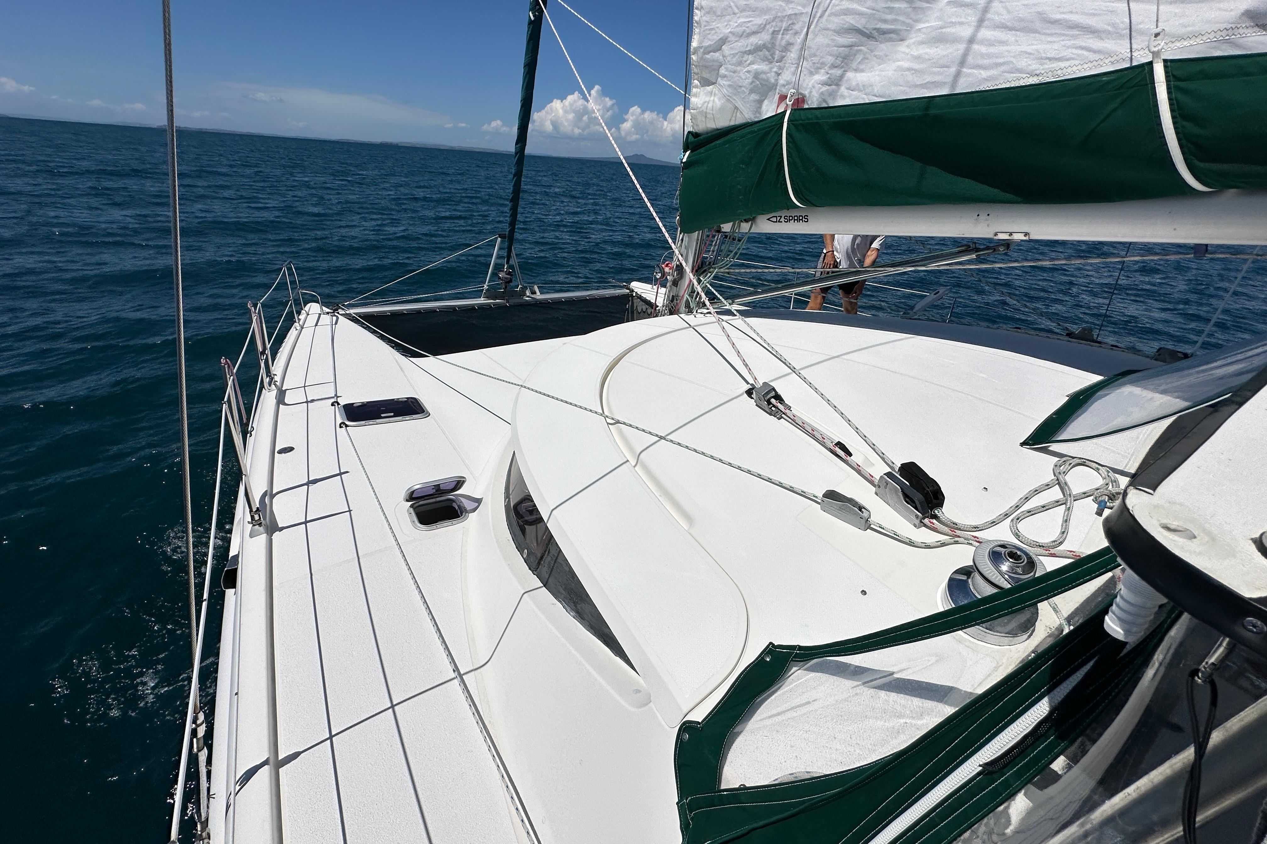 Sailing on a 1995 Fountaine Pajot Athena 38 catamaran in open sea.