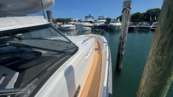 Nimbus T11 2025 yacht docked at marina with other boats in background.